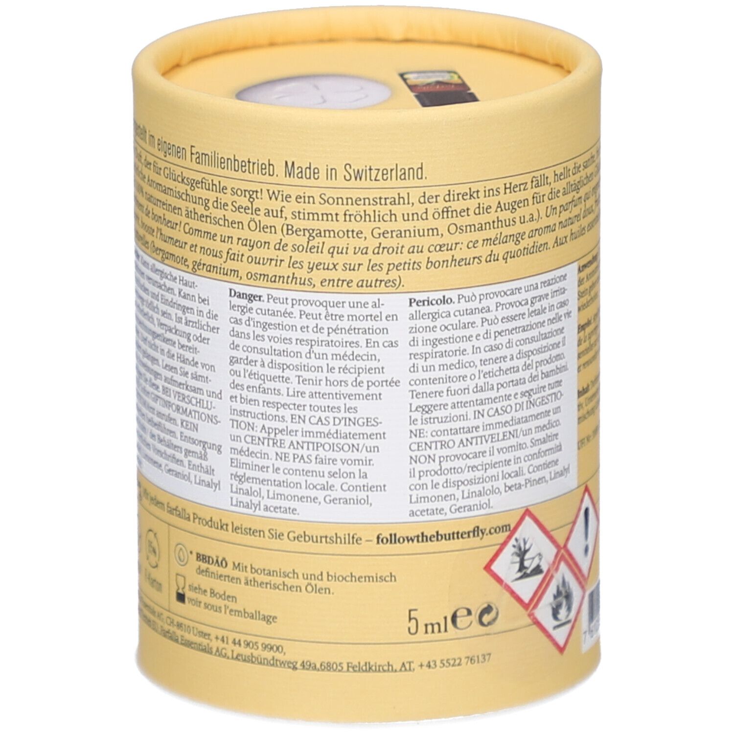 Zylindrische Verpackung, Rückseite. Text über Inhaltsstoffe, Gefahrenhinweise. Botanische und biochemische ätherische Öle. 5ml. Gefahrensymbole.