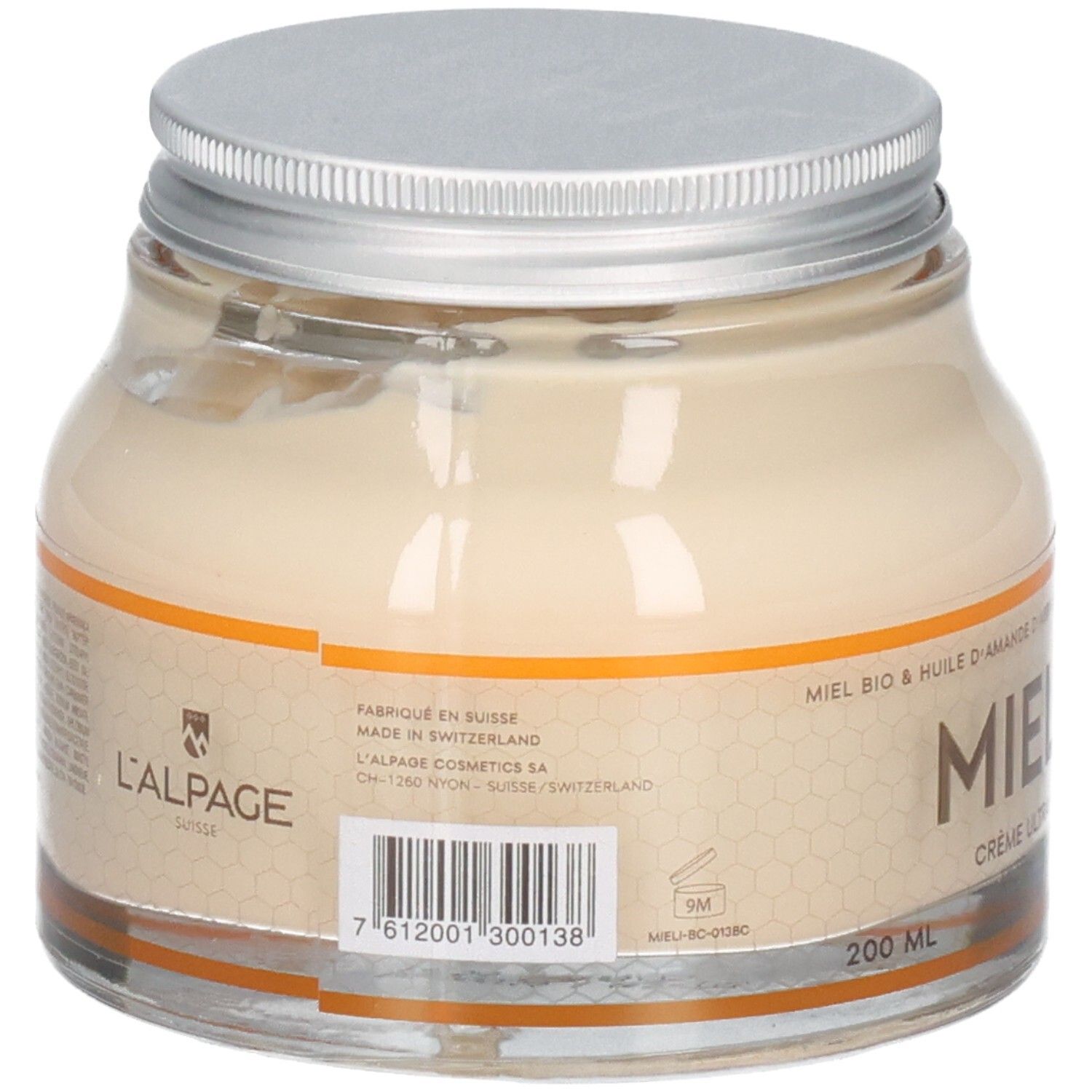 Pot en verre avec crème. Couvercle argenté. Inscription: Mielicime, Crème ultra-nourrissante corps. Huile de miel et d'abricot.