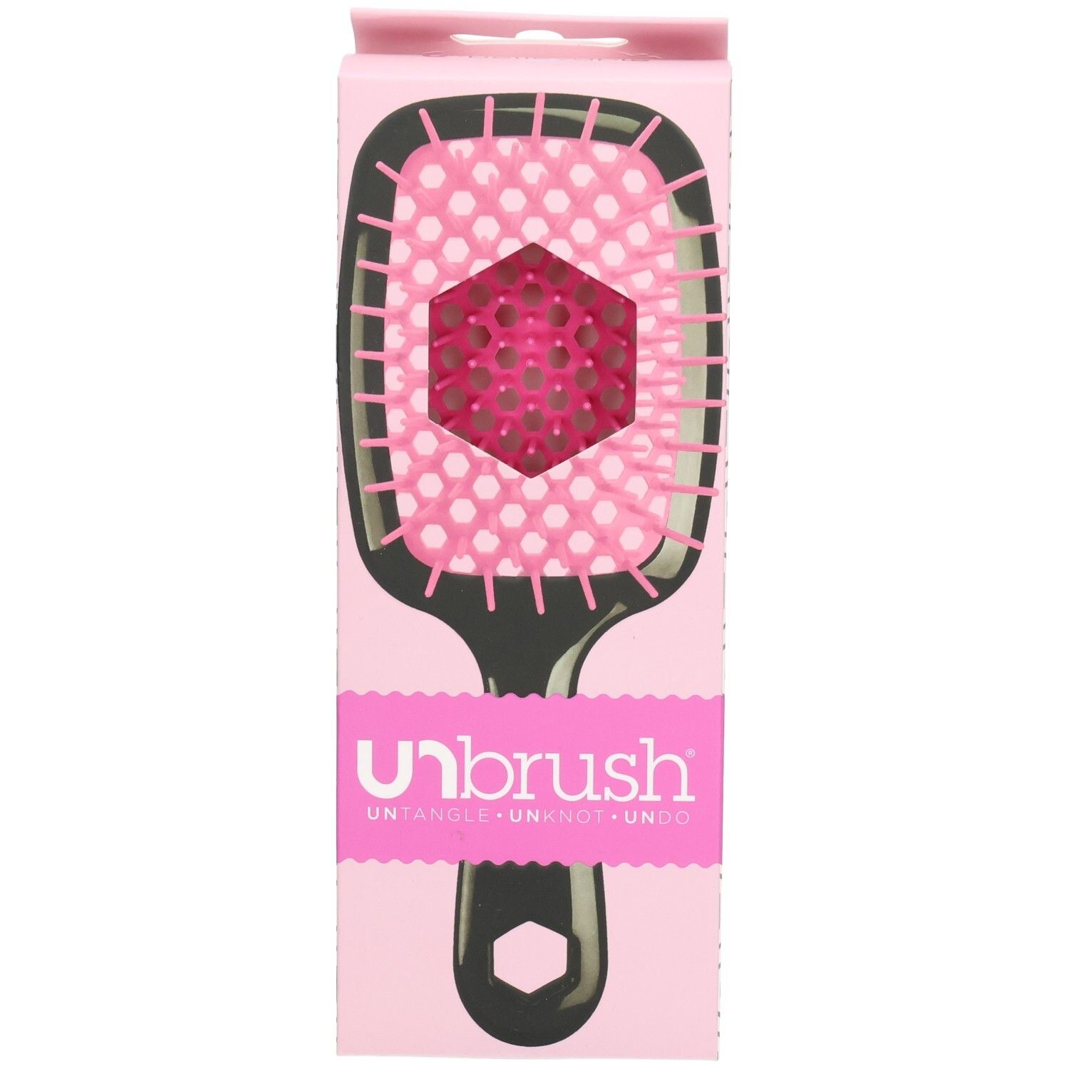 UNBRUSH Entwirrbürste in Verpackung. Schwarzer Griff, pinke Borsten. Pinke Verpackung mit Markenlogo.