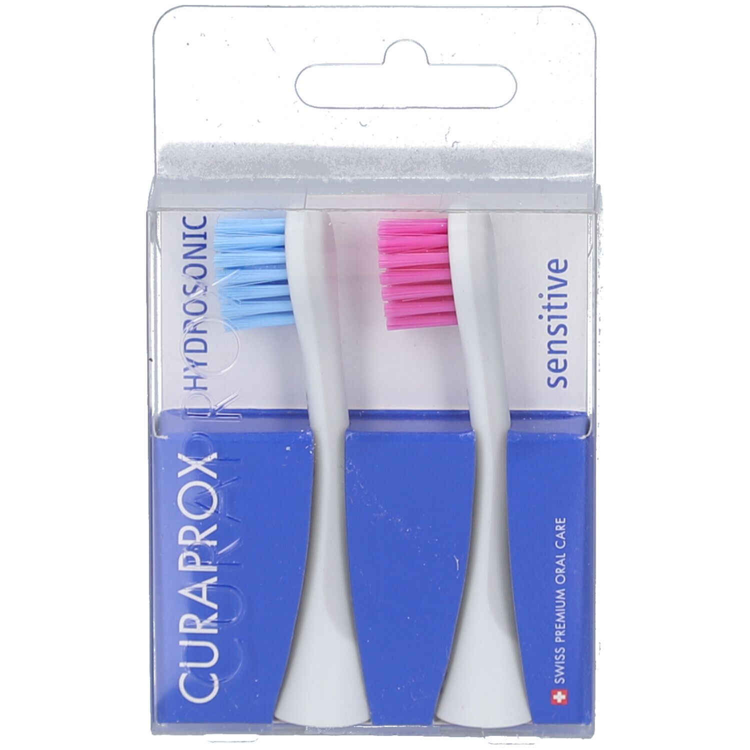 Zwei blaue und pinkfarbene Hydrosonic-Ersatzbürsten in einer transparenten Verpackung. CURAPROX-Logo und Schriftzug "sensitive" sichtbar.