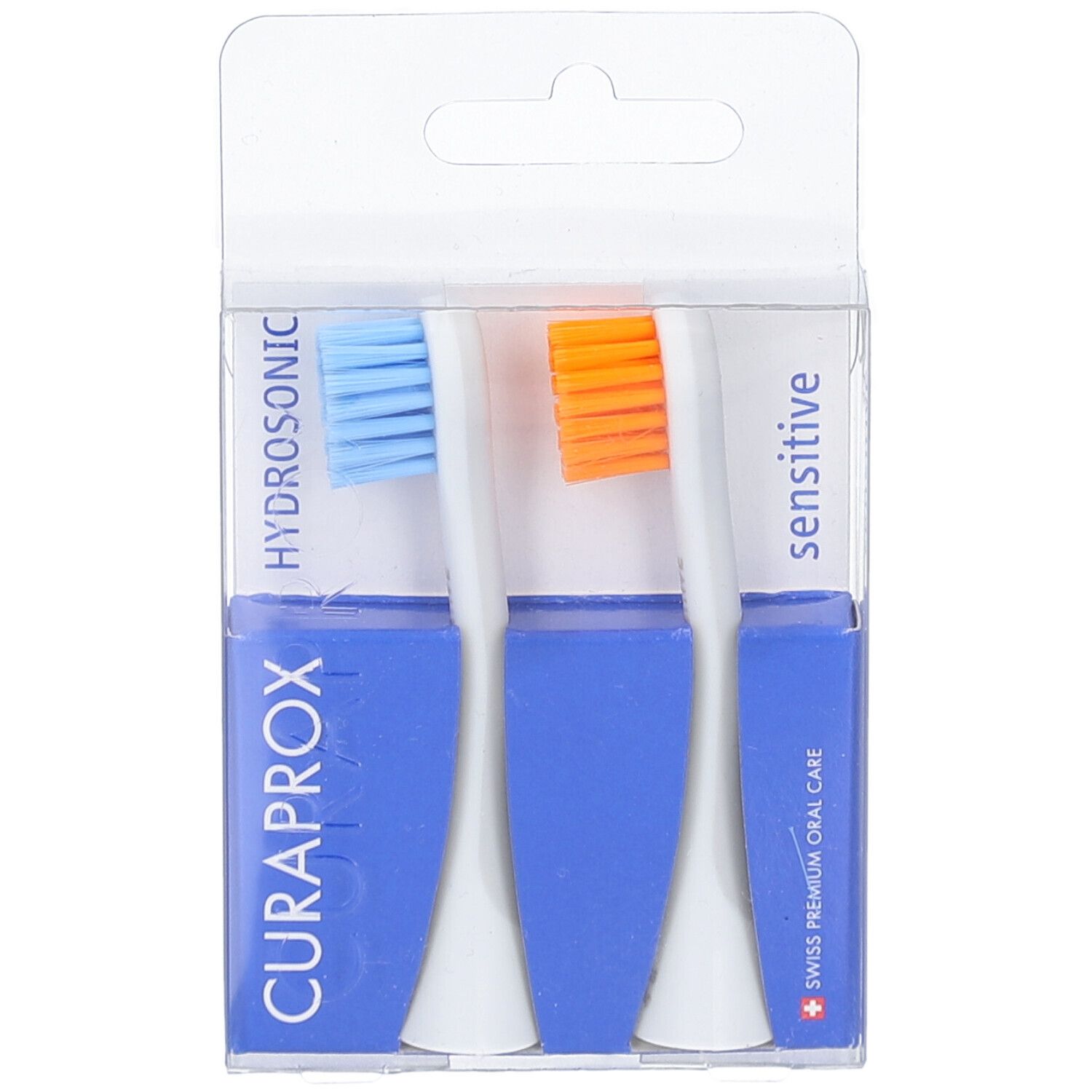 Zwei Bürstenköpfe in einer transparenten Verpackung. Blaue und orangefarbene Borsten. Blaue Verpackung mit CURAPROX-Logo.