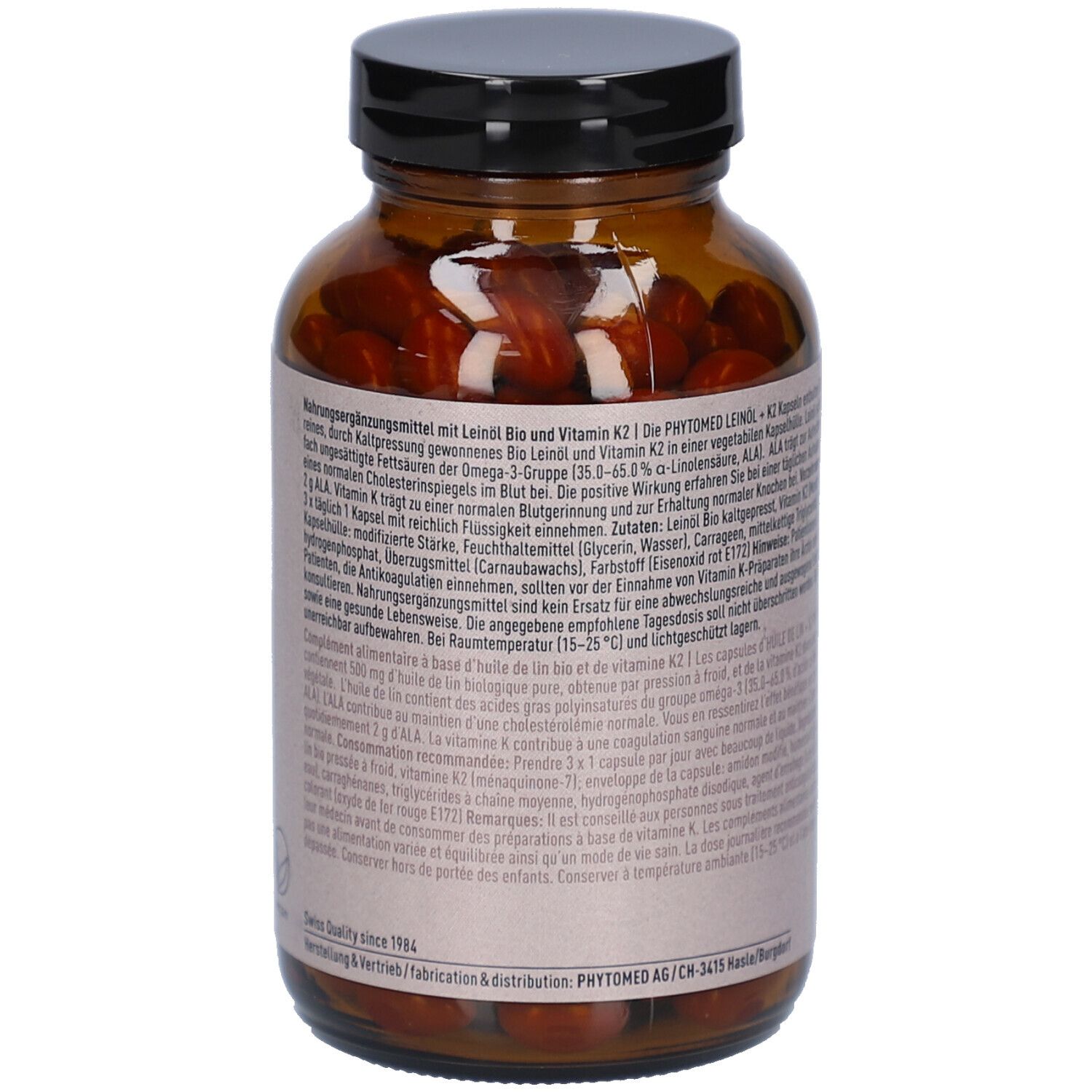Flacon en verre brun avec étiquette. Texte: Complément alimentaire avec huile de lin, K2. Contient 200 gélules. Marque: PHYTOMED.