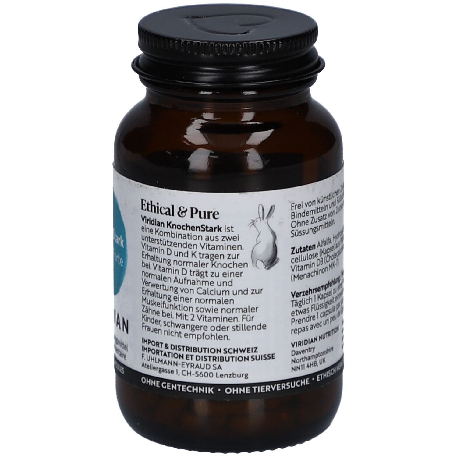 Flacon en verre brun, bouchon noir. Étiquette avec informations produit, label Vegan et symbole lapin.