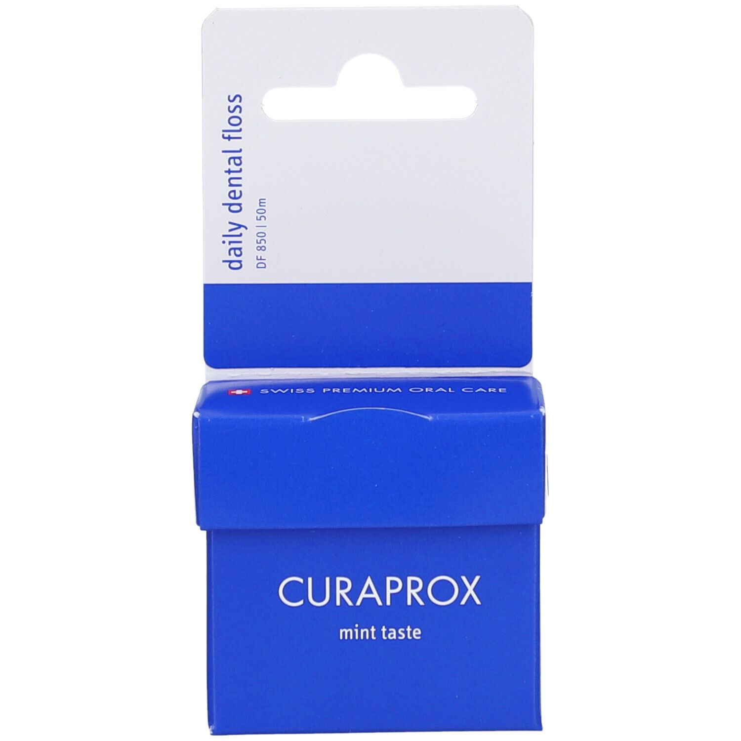 Emballage bleu avec suspension blanche. Logo CURAPROX et texte. Contient du fil dentaire. Inscription : mint taste.