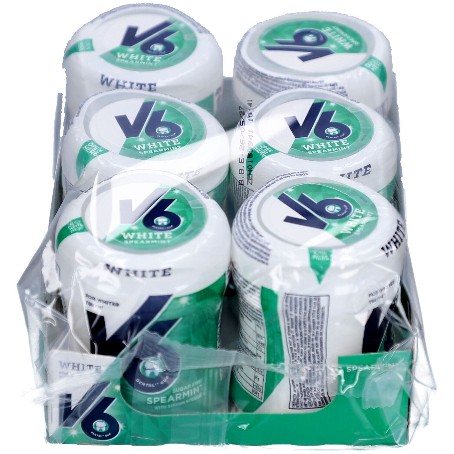 Packung mit sechs Dosen Kaugummi. Jede Dose hat einen weißen Deckel mit grünem Logo und Schriftzug. Klarsichtfolie umhüllt die Packung.