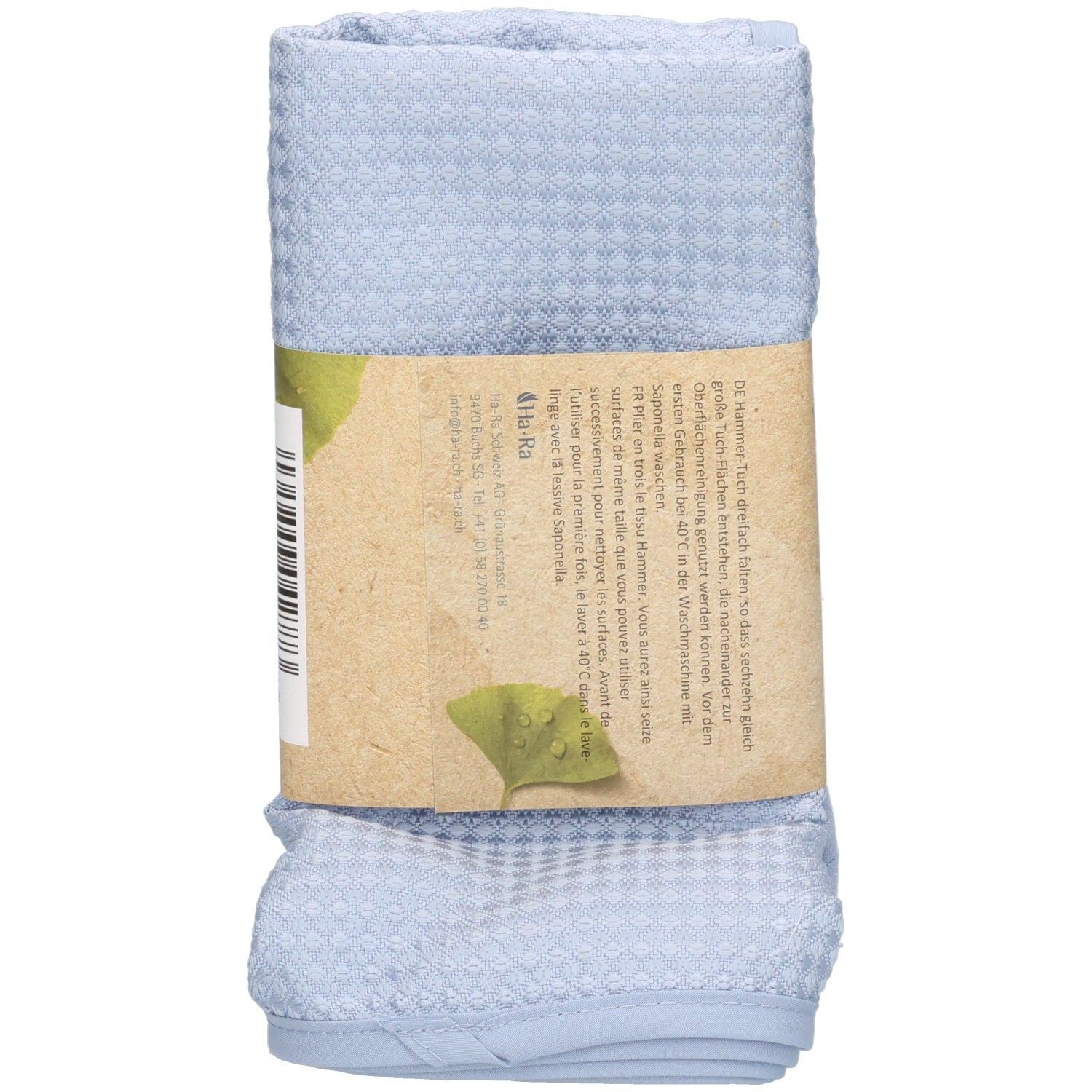 Gerolltes blaues Hammer-Tuch mit Papierbanderole. Aufdruck: Ha-Ra Professional, Produktname, Text und Logo.