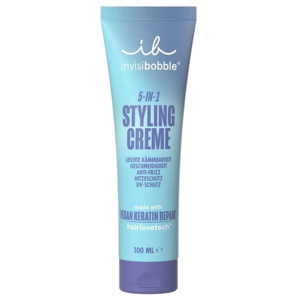 Hellblaue Tube mit lila Verschluss. Aufschrift: 5-in-1 Styling Creme, leichte Kämmbarkeit, Anti-Frizz, Hitzeschutz, UV-Schutz. Marke: invisibobble.