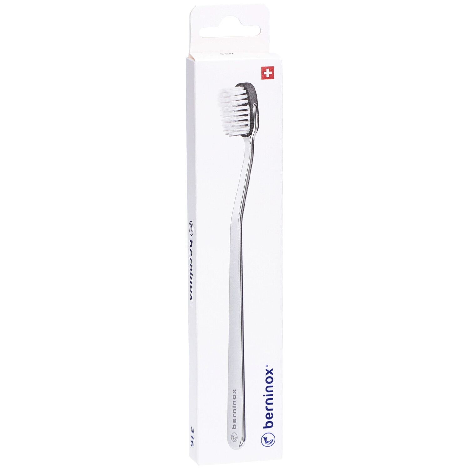 Zahnbürste in weißer Verpackung. Bürstenkopf mit schwarzen Borsten. Schweizer Kreuz und Logo sichtbar.