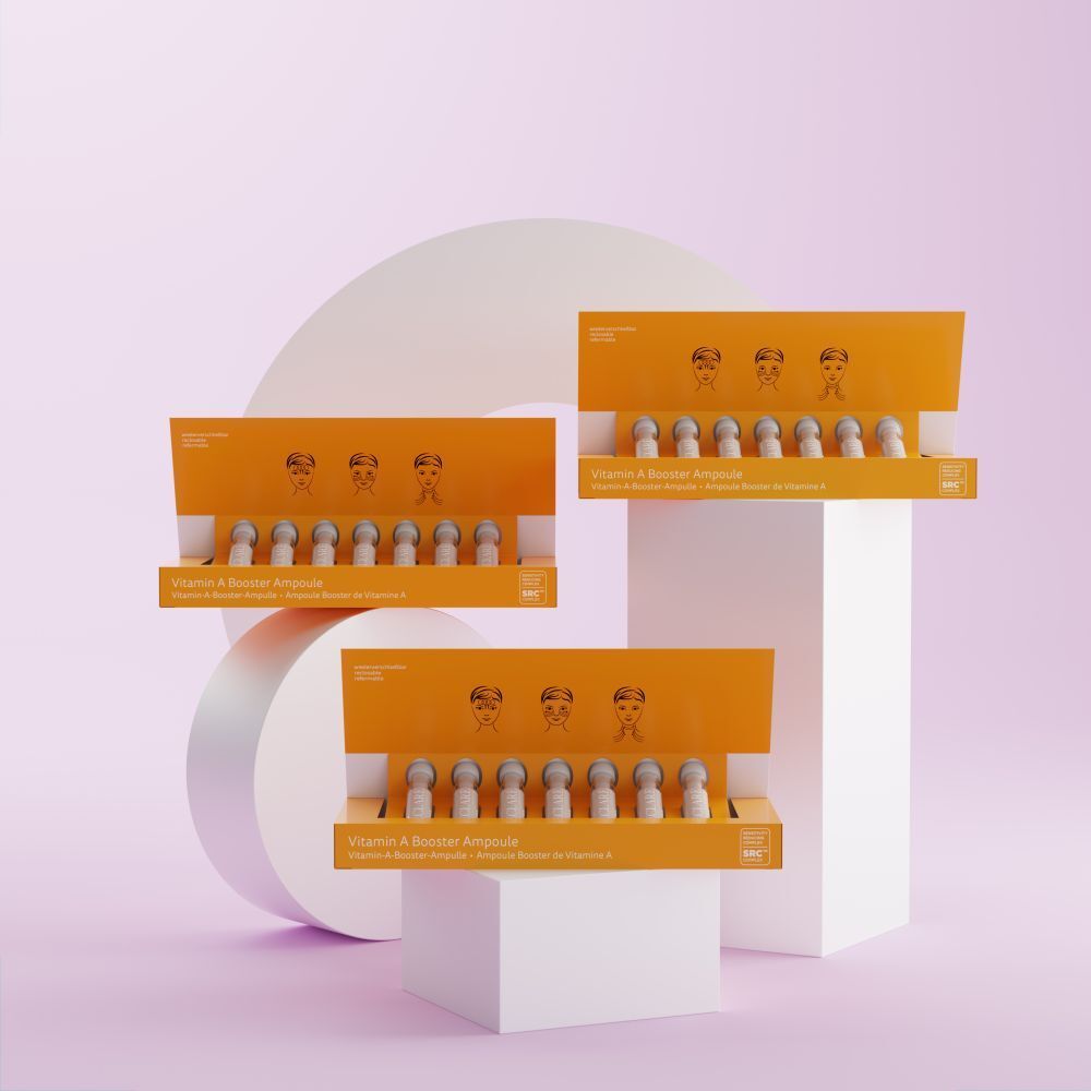 Trois boîtes jaunes DECLARÉ Vitamin A Booster Ampoule. Inscription rose "VITAMIN". Chaque boîte contient des ampoules.