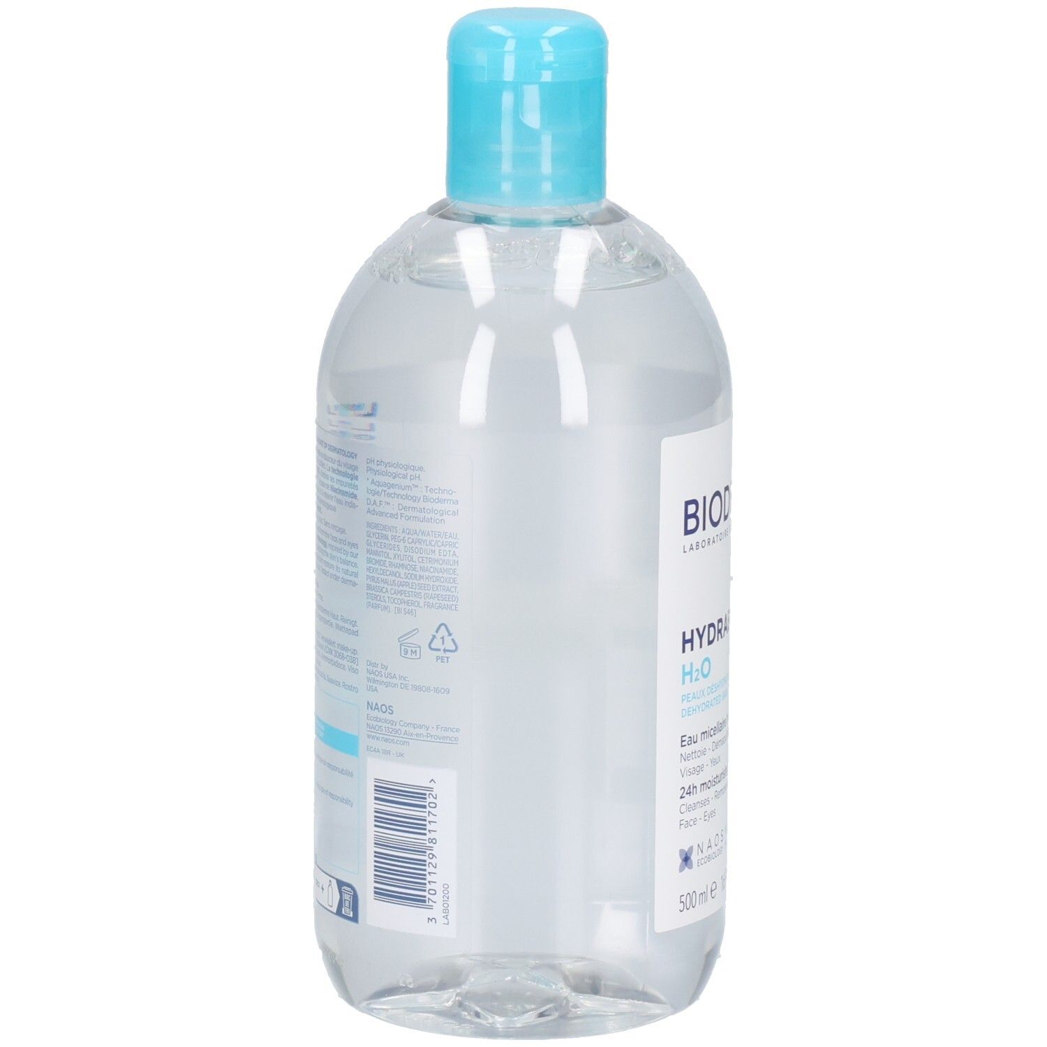 Bouteille transparente avec bouchon bleu. Dos avec texte. Contient un liquide clair.