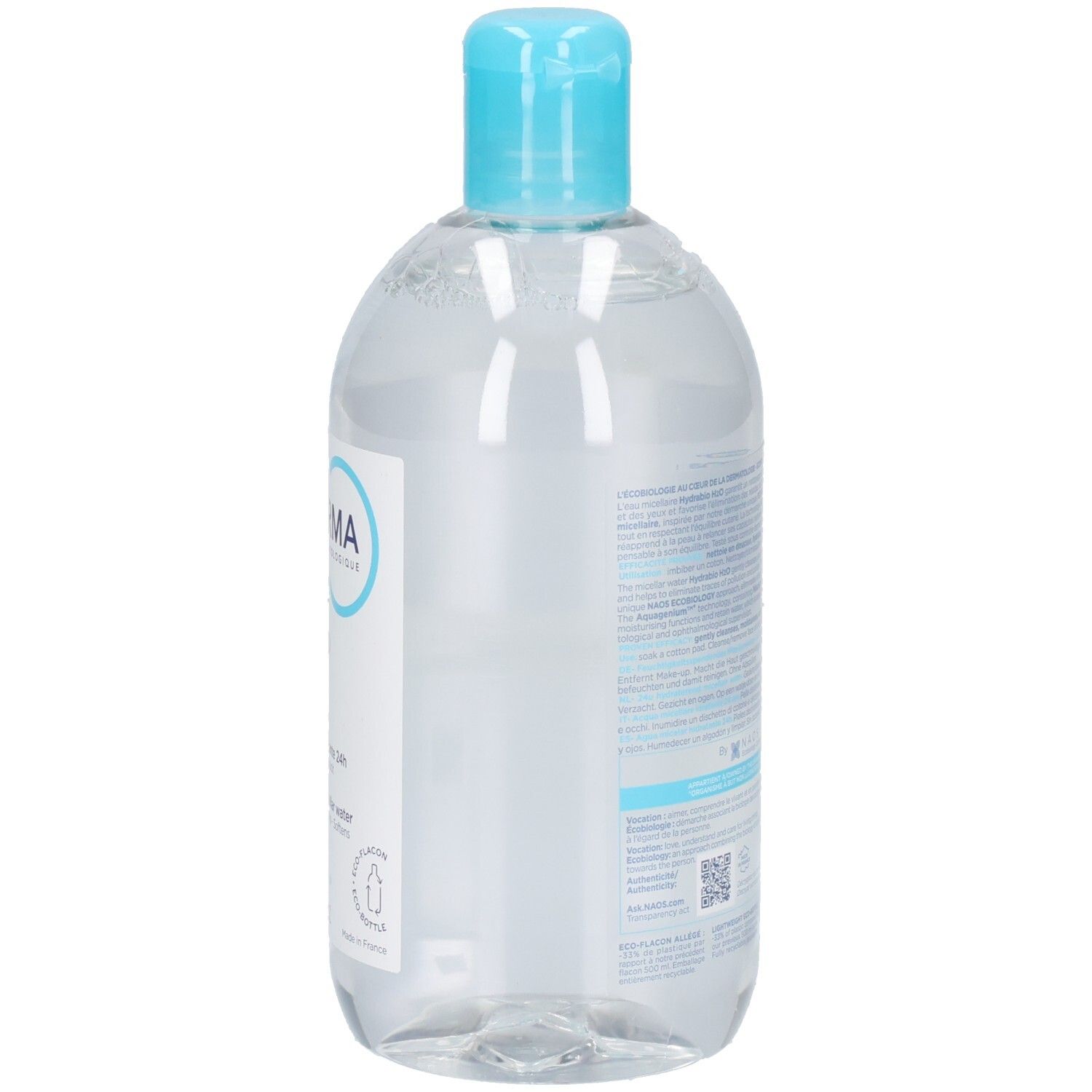 Bouteille transparente avec bouchon bleu. Dos avec texte. Contient un liquide clair.