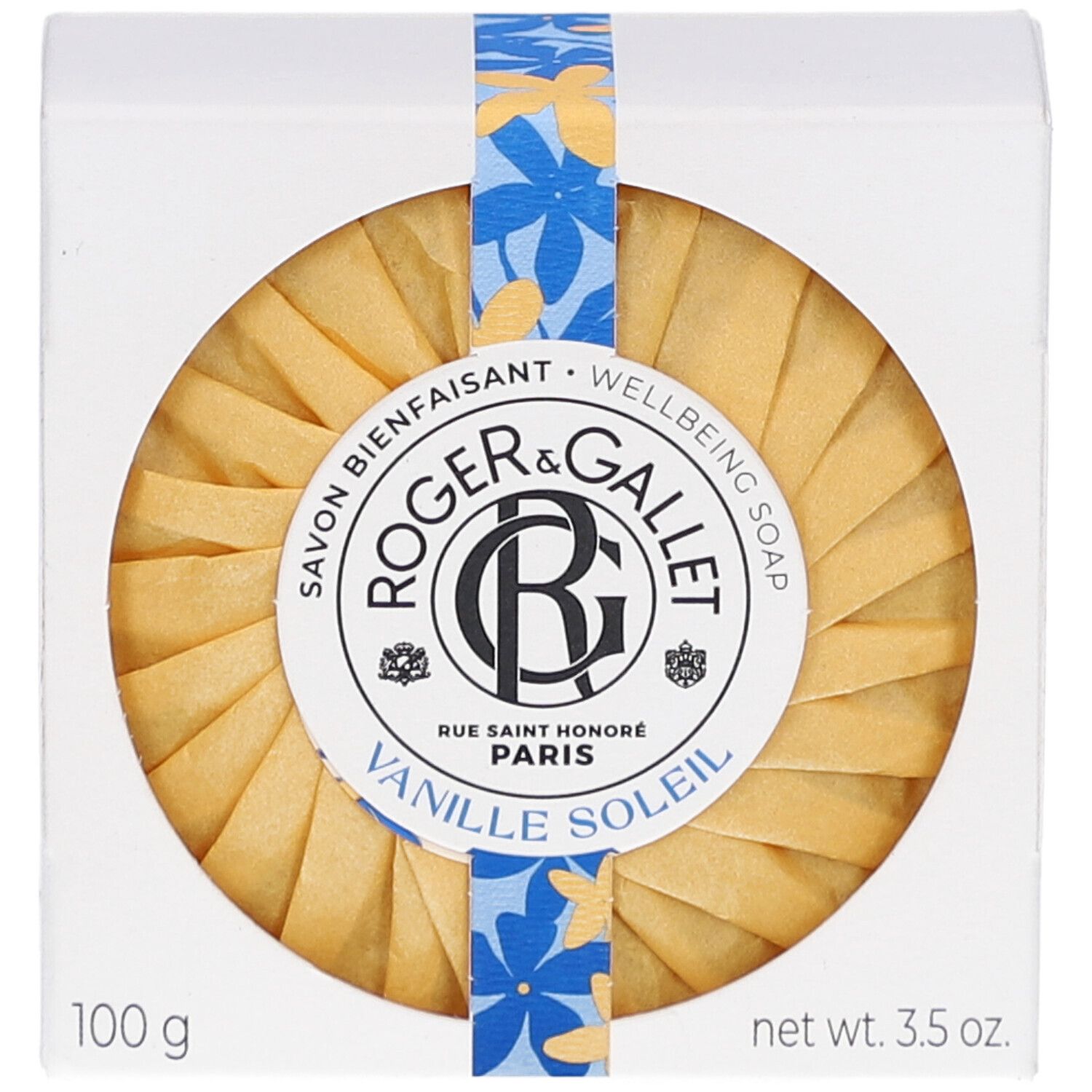 Savon rond dans son emballage. Inscription: Roger & Gallet Vanille Soleil. Ruban fleuri.