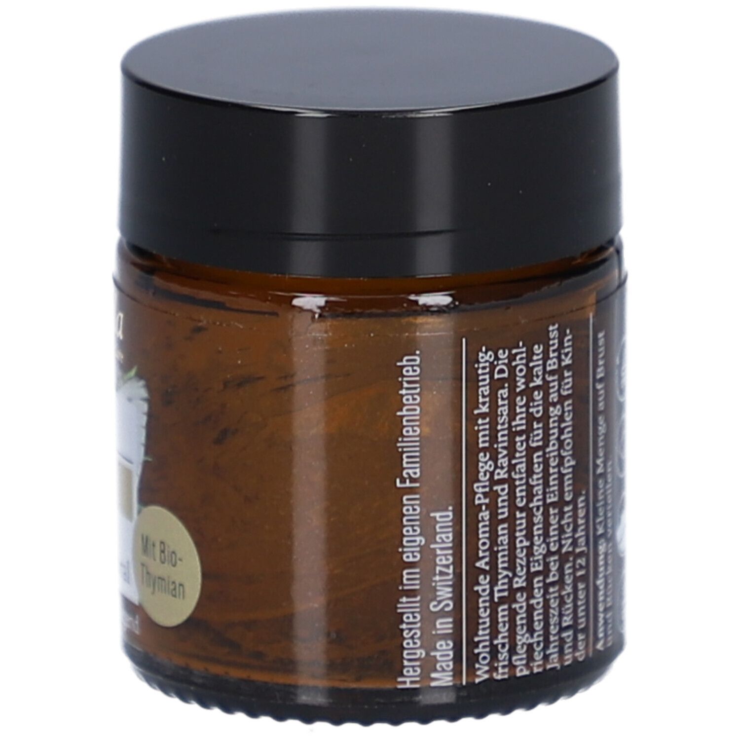 Braunglas mit schwarzem Deckel. Aufkleber mit Text: Hergestellt in der Schweiz. Text: Kleine Menge auf Brust und Rücken verteilen.