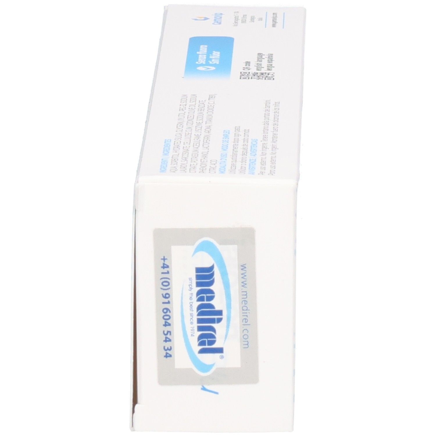 Boîte de dentifrice, vue latérale. Blanche avec texte et logo.