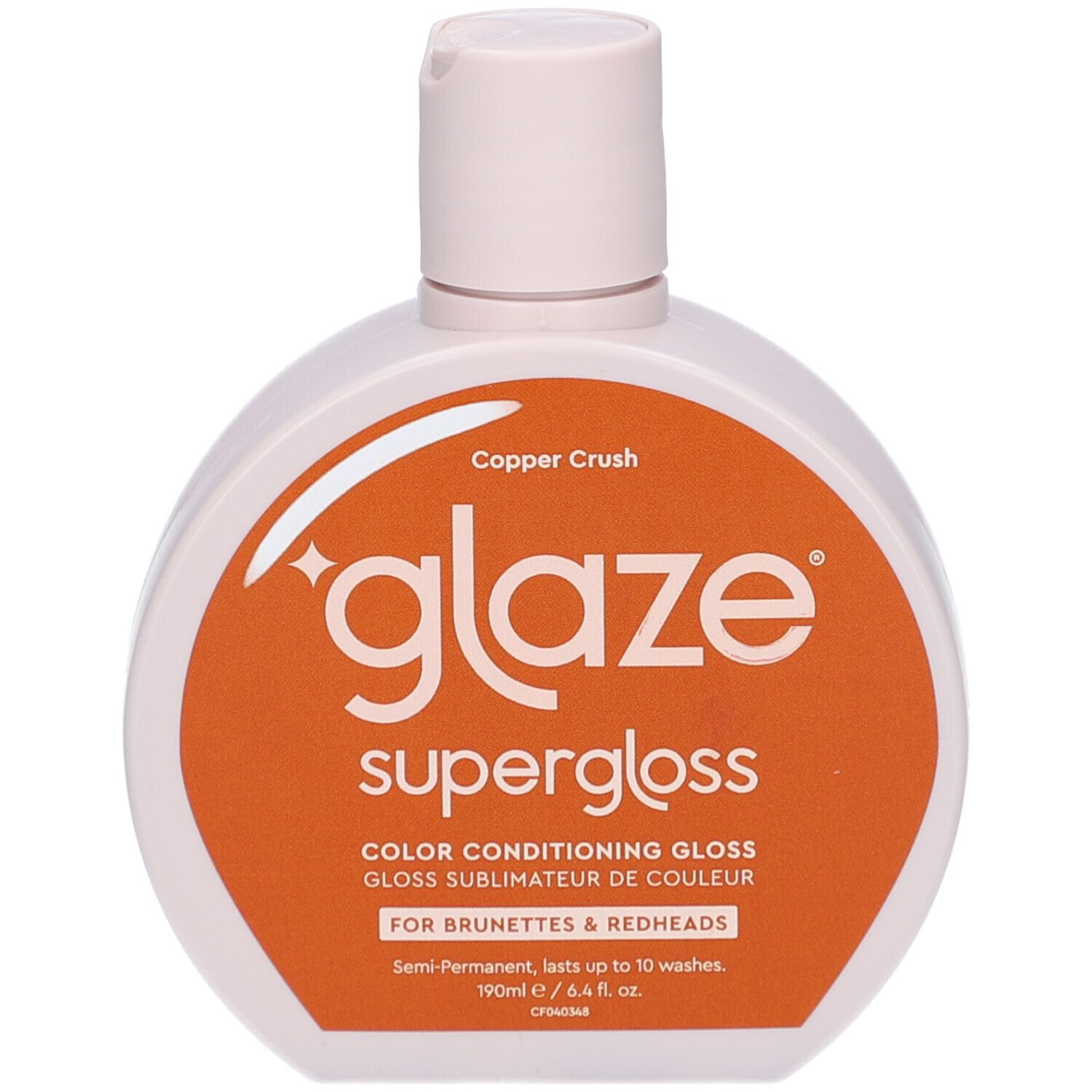 Flacon de gloss. Étiquette blanche et orange avec nom du produit. Bouchon en haut.