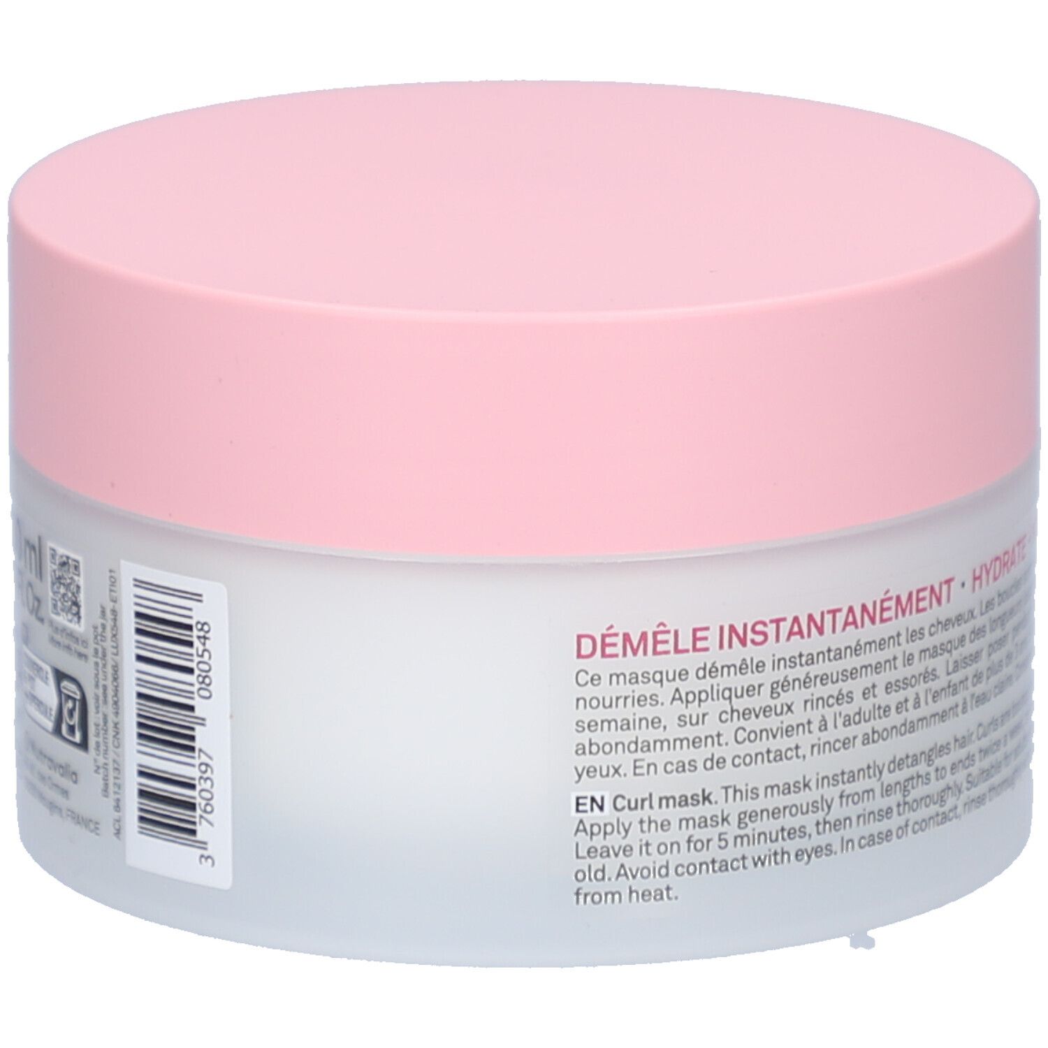 Pot rond avec couvercle rose. Texte: DÉMÊLE INSTANTANÉMENT - HYDRATE - NOURRIT. Pour cheveux bouclés. Instructions en français et anglais.