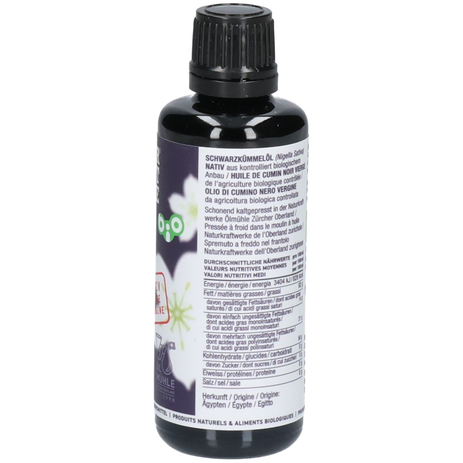 Gros plan de l'arrière d'une bouteille de 50ml d'huile de cumin noir. Étiquette avec informations nutritionnelles et origine.