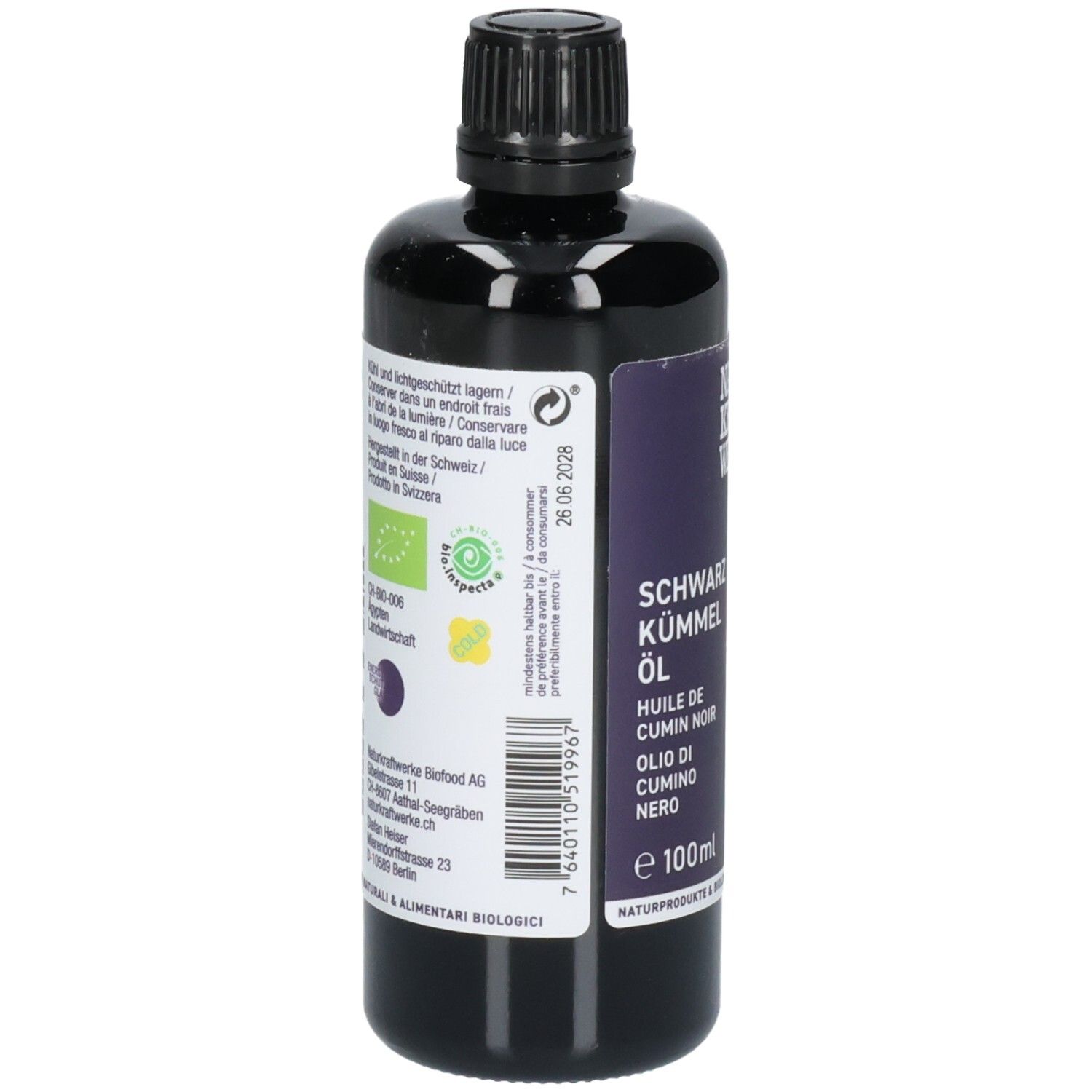 Arrière d'une bouteille noire d'huile de cumin noir avec sceau bio et informations nutritionnelles.