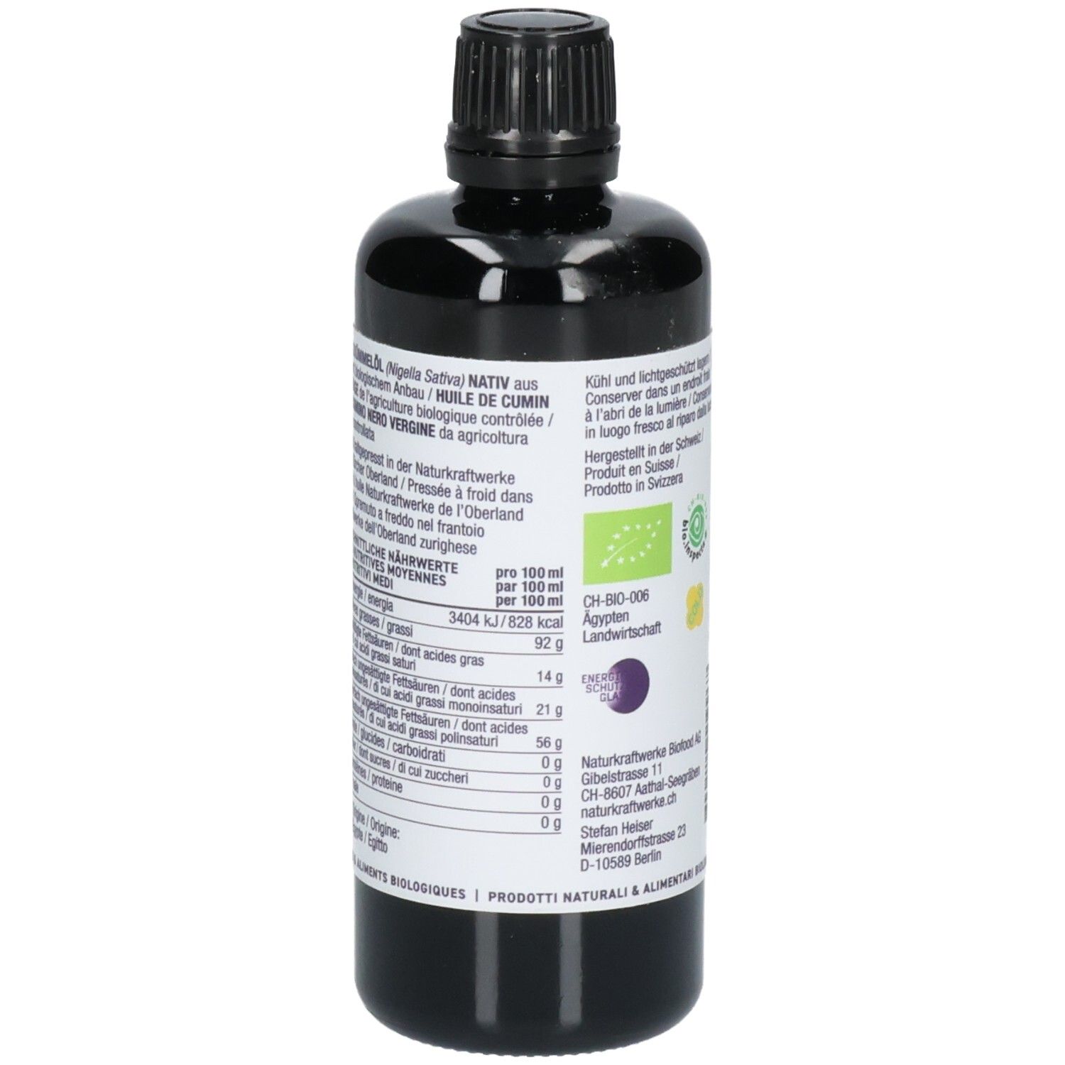 Arrière d'une bouteille noire d'huile de cumin noir avec informations nutritionnelles détaillées et sceau bio.