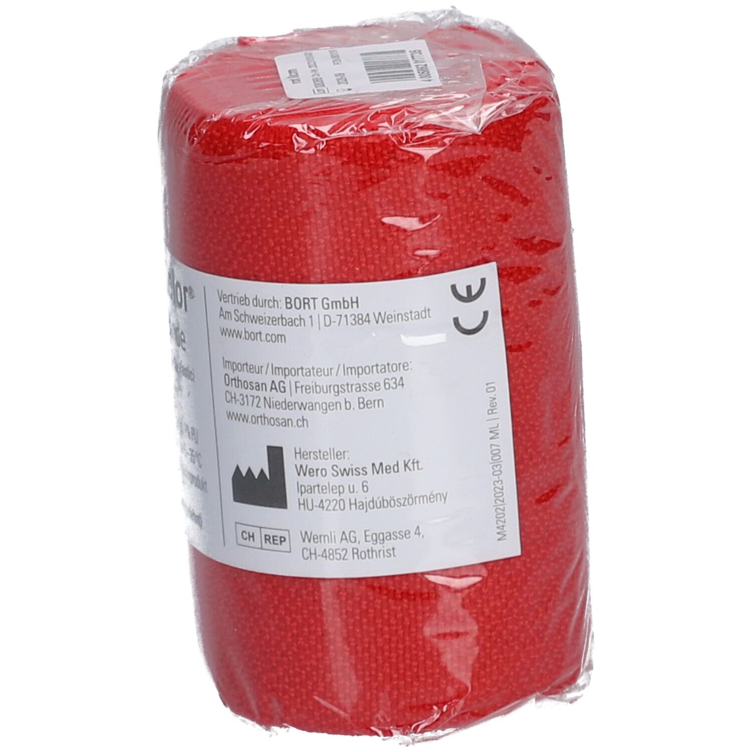 Bande élastique rouge emballée. Marquage CE. Informations et adresse du produit sur l'étiquette.