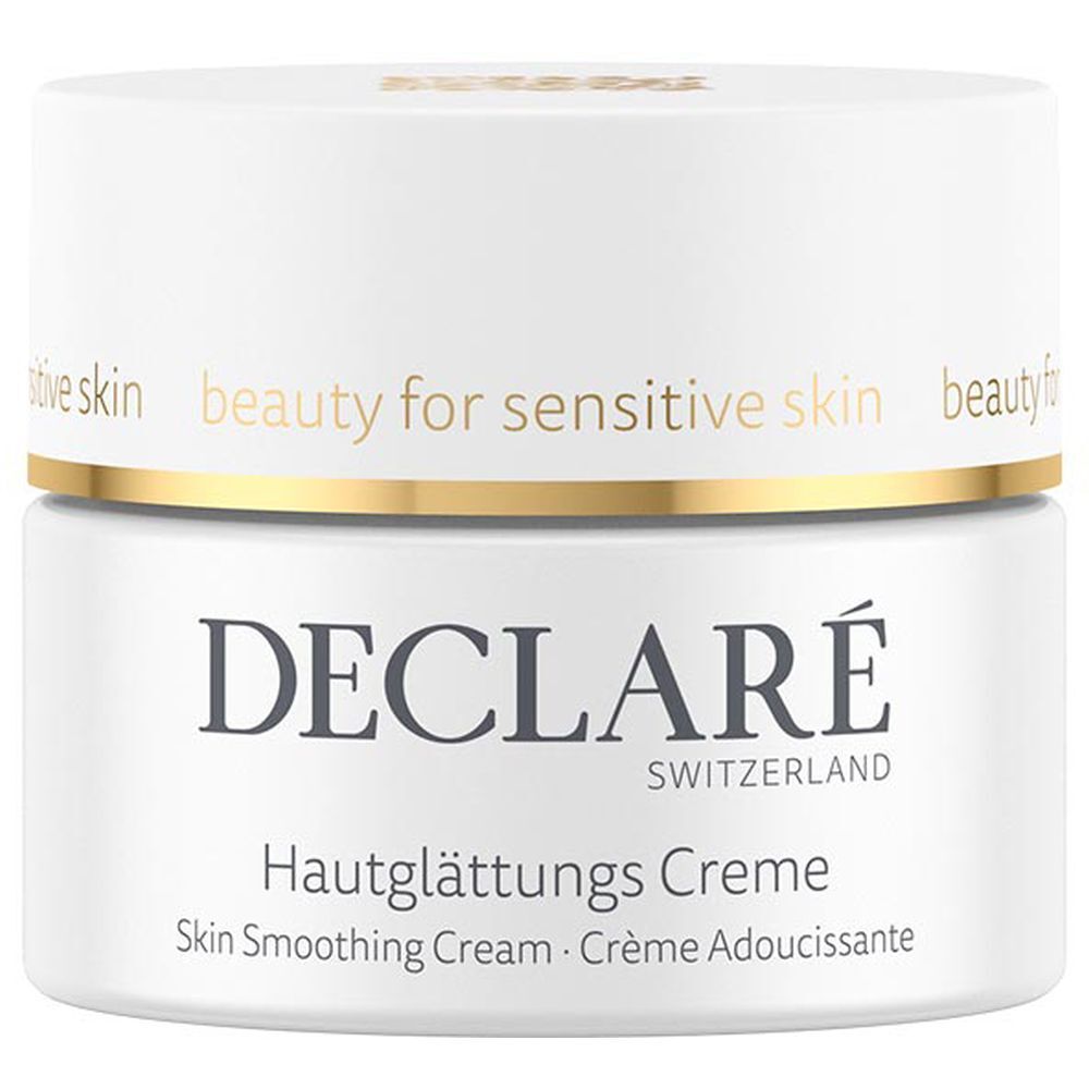 Pot de crème blanc avec bord doré. Inscription : DECLARÉ, Hautglättungs Creme. Texte : Skin Smoothing Cream, Crème Adoucissante.