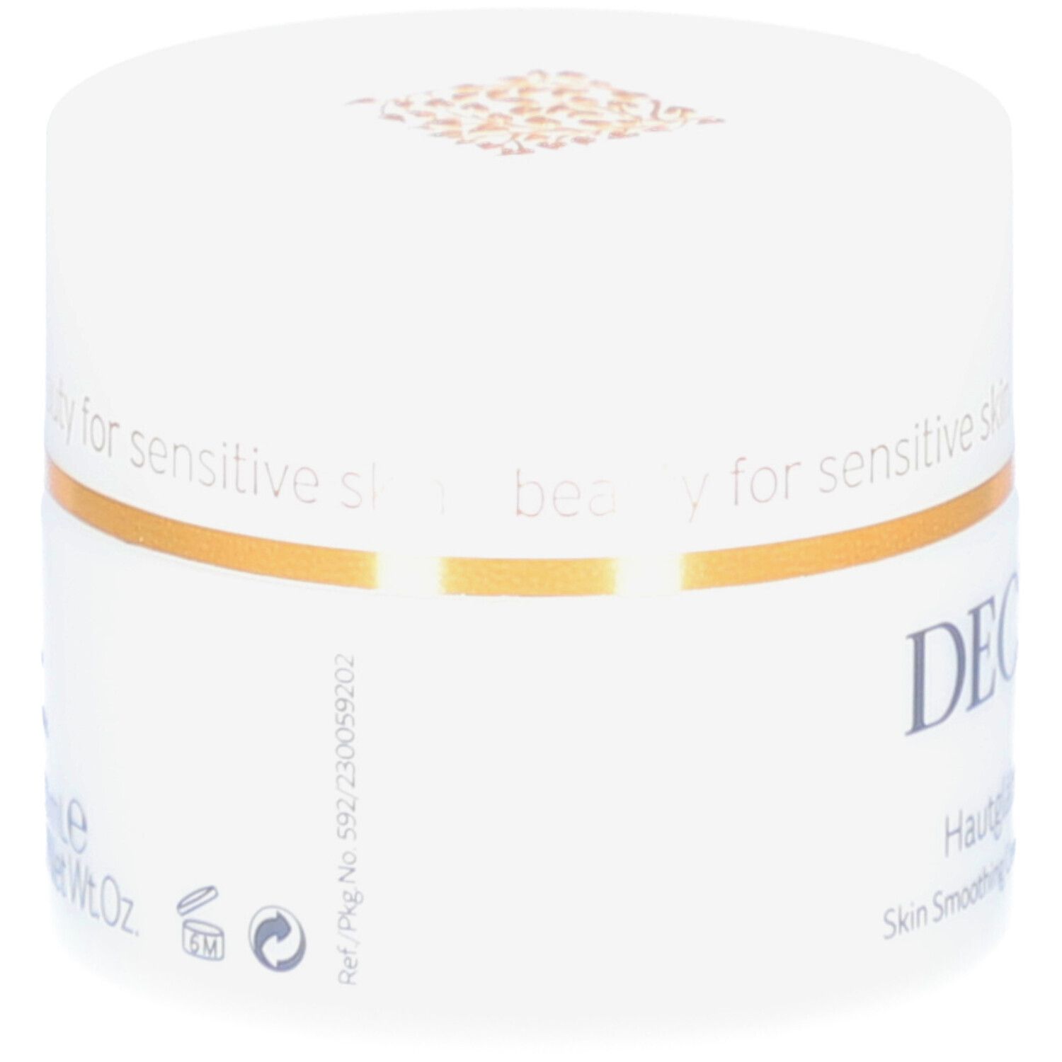 Pot blanc avec couvercle. Bande dorée. Logo DECLARÉ et nom du produit. Inscription: Crème Adoucissante.