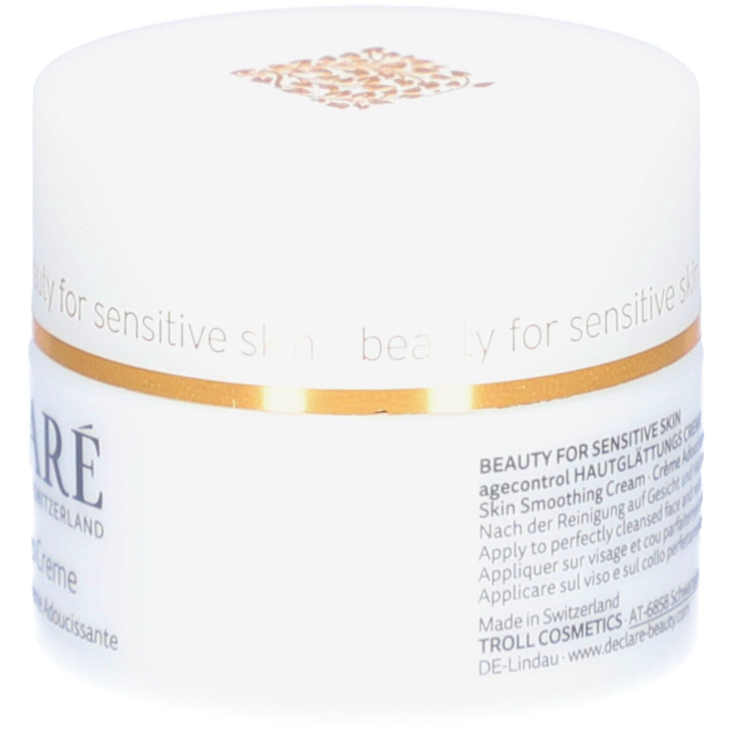 Pot blanc avec couvercle. Bande dorée. Logo DECLARÉ et nom du produit. Inscription: Crème Adoucissante. 50 ml.