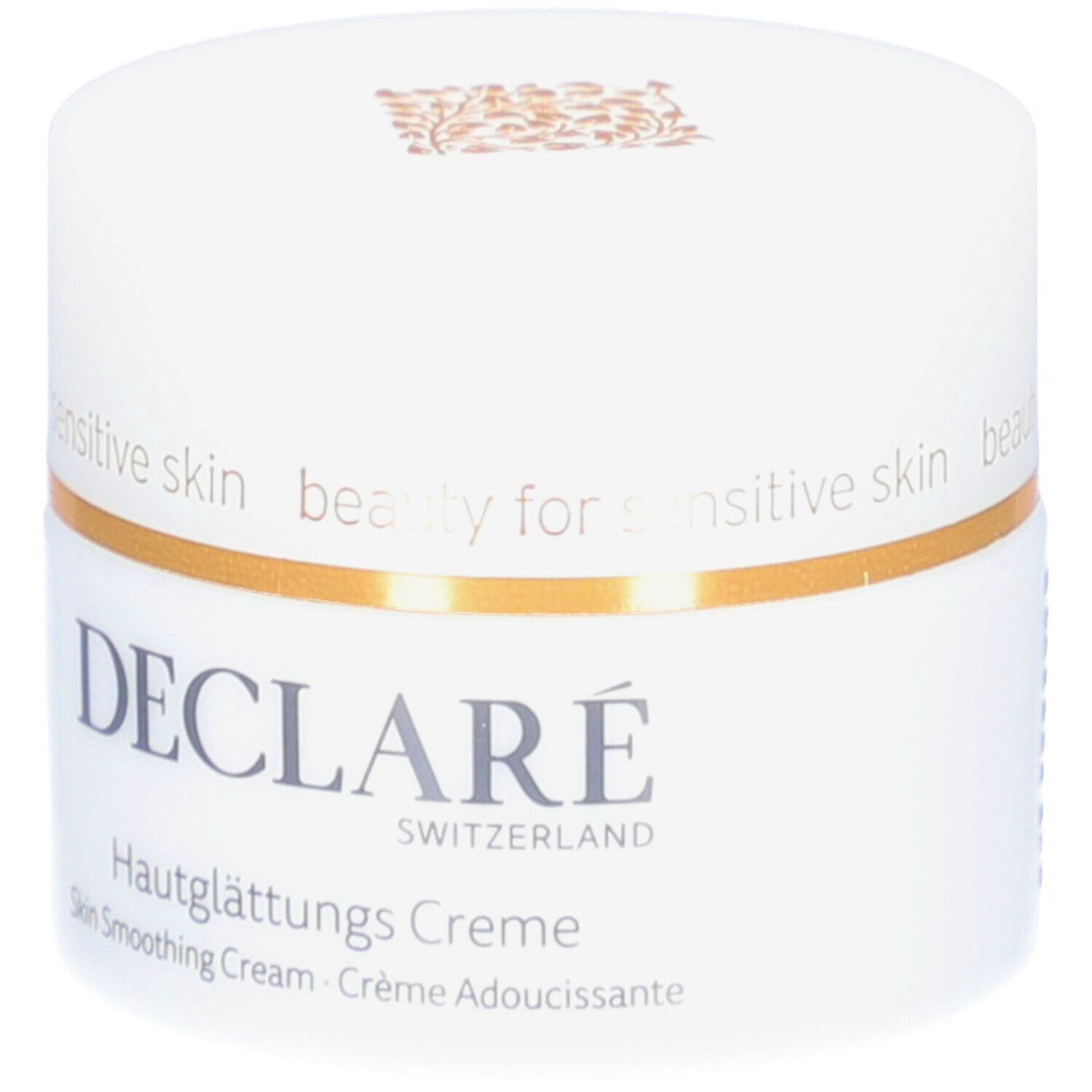 Pot blanc avec couvercle. Bande dorée. Logo DECLARÉ et nom du produit. Inscription: Crème Adoucissante.