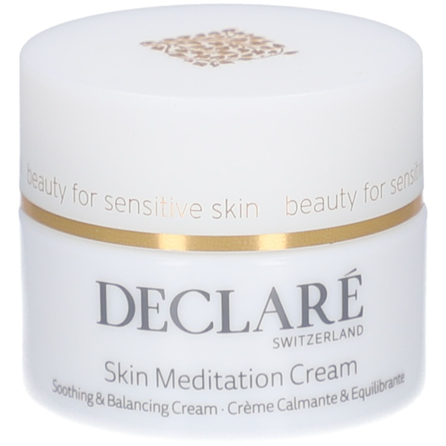 Pot de crème blanc avec bord doré. Inscription : DECLARÉ SWITZERLAND, Skin Meditation Cream. Crème apaisante et équilibrante.