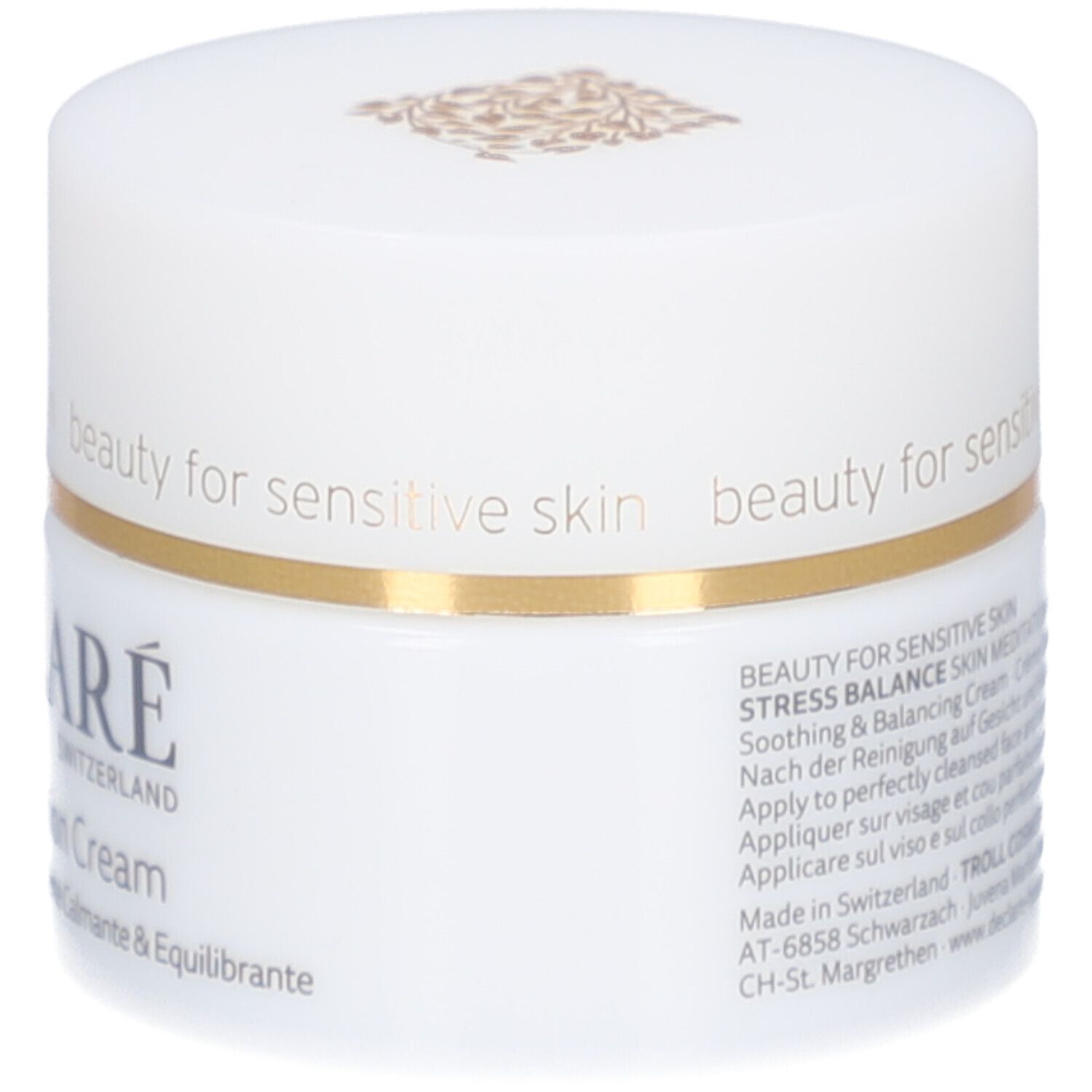Pot de crème blanc avec bord doré. Inscription : DECLARÉ SWITZERLAND, Skin Meditation Cream. Texte sur le côté.
