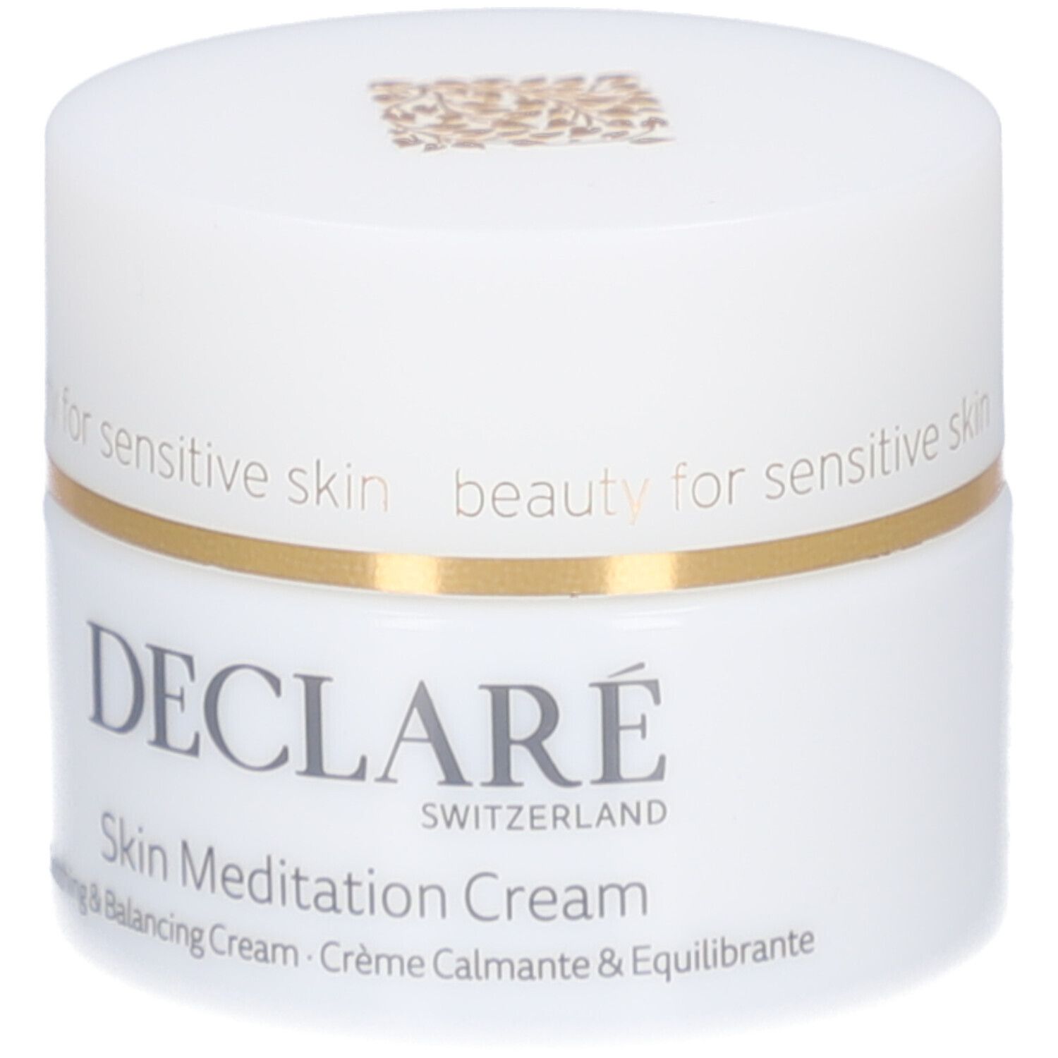 Pot de crème blanc avec bord doré. Inscription : DECLARÉ SWITZERLAND, Skin Meditation Cream. Crème apaisante et équilibrante.
