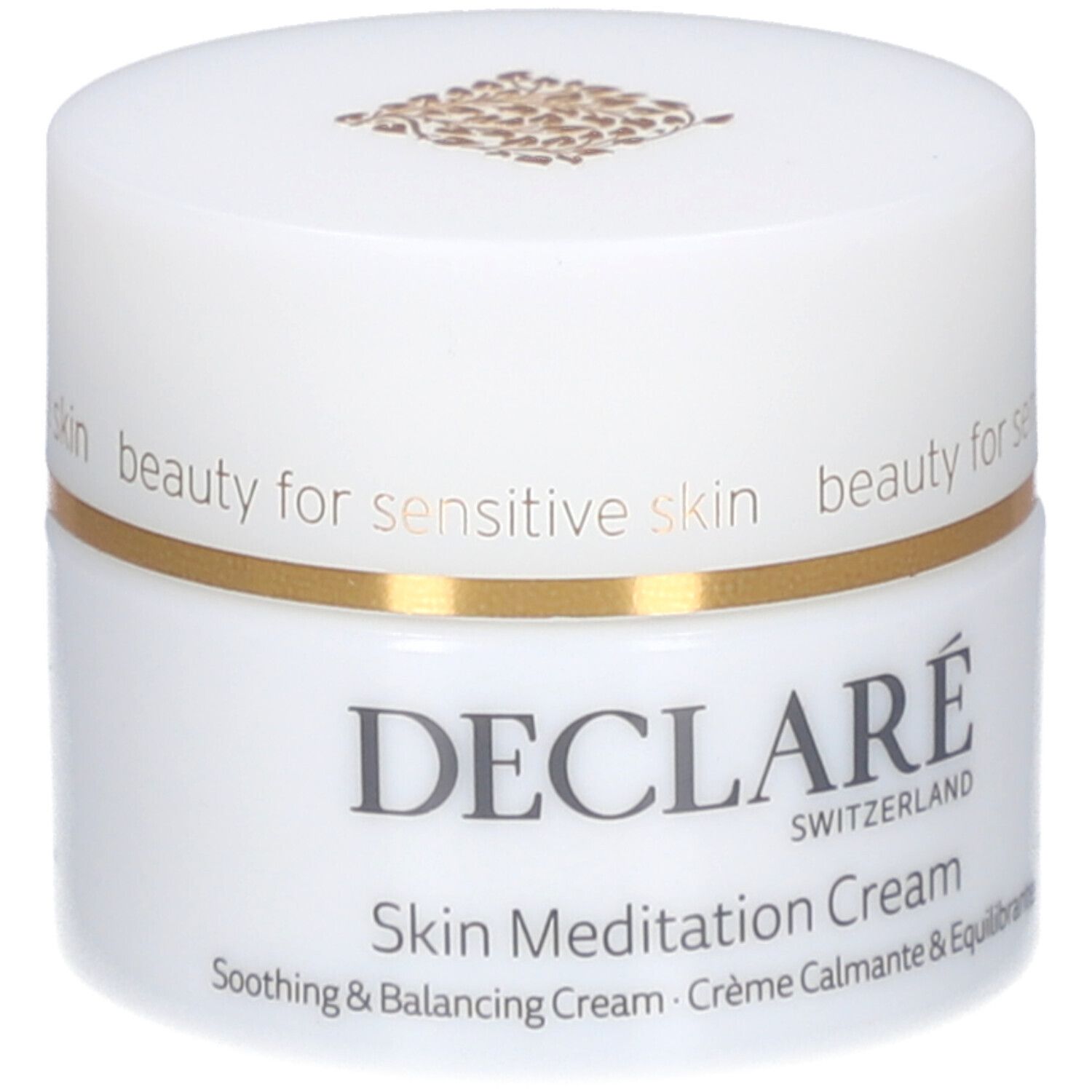Pot de crème blanc avec bord doré. Inscription : DECLARÉ SWITZERLAND, Skin Meditation Cream. Crème apaisante et équilibrante.