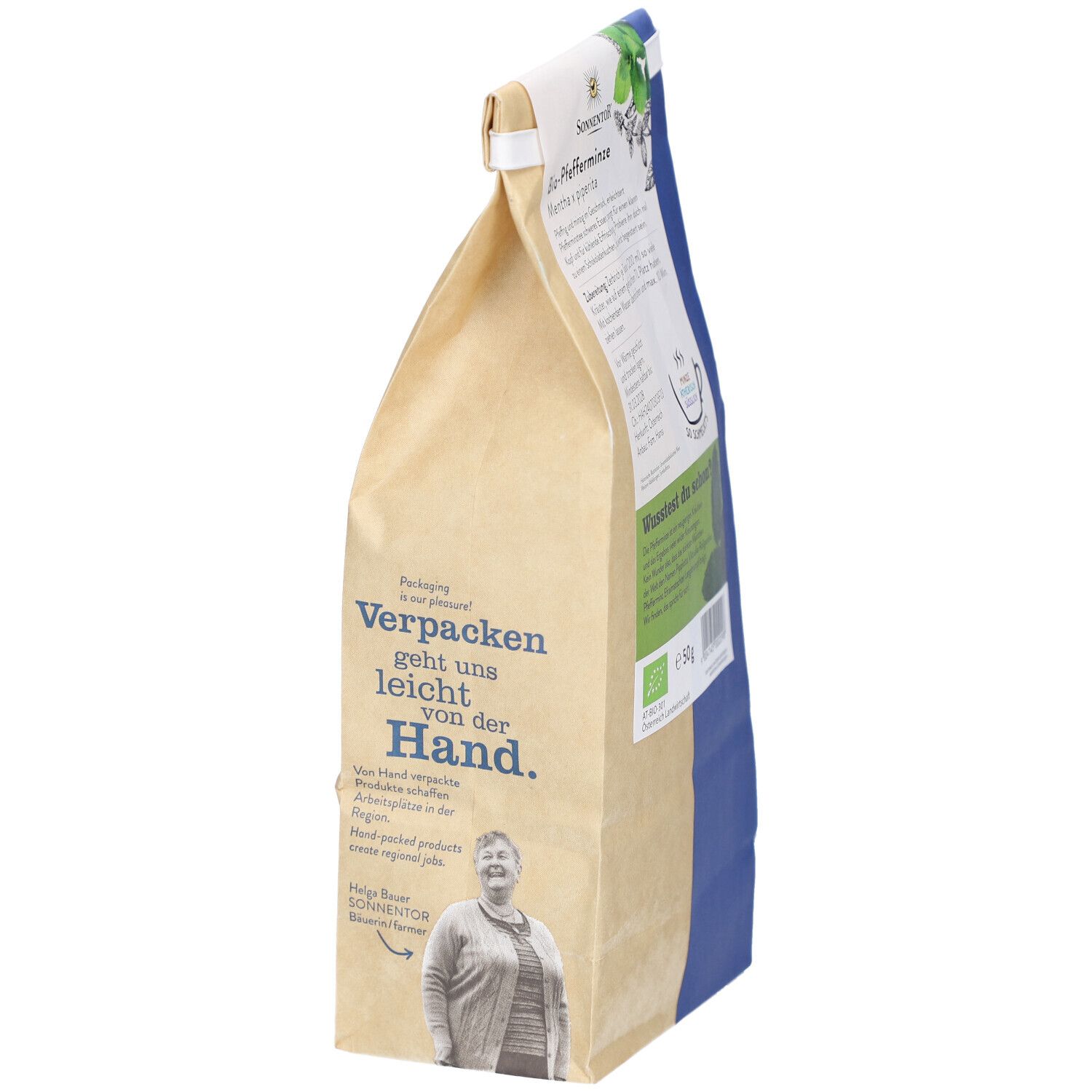 Sachet de thé BIO avec inscription : L'emballage est facile pour nous. Image d'Helga Bauer. Logo SONNENTOR et label bio.