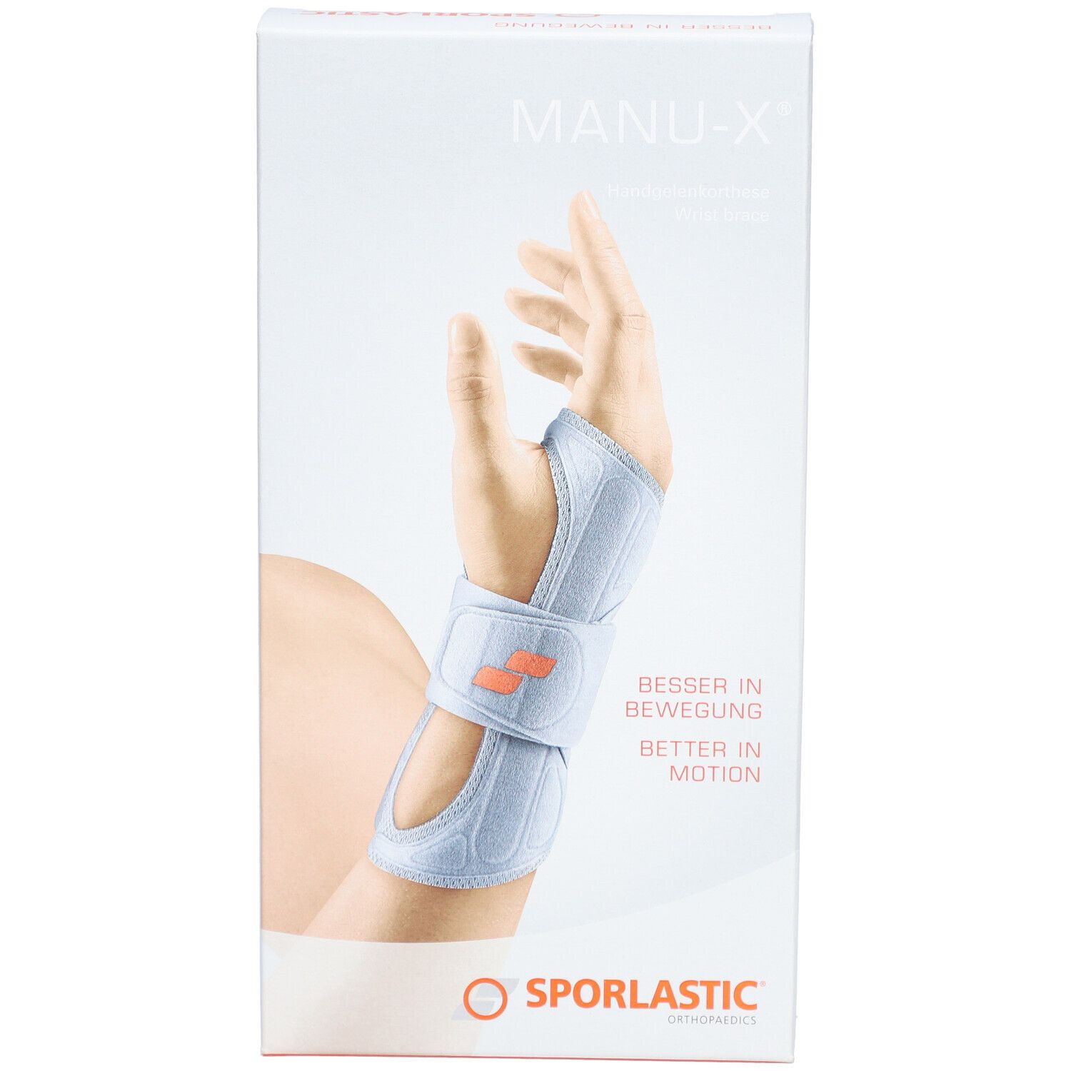 Emballage de l'orthèse de poignet MANU-X. Montre une main portant l'orthèse. Logo SPORLASTIC en bas. Texte : BESSER IN BEWEGUNG / BETTER IN MOTION.