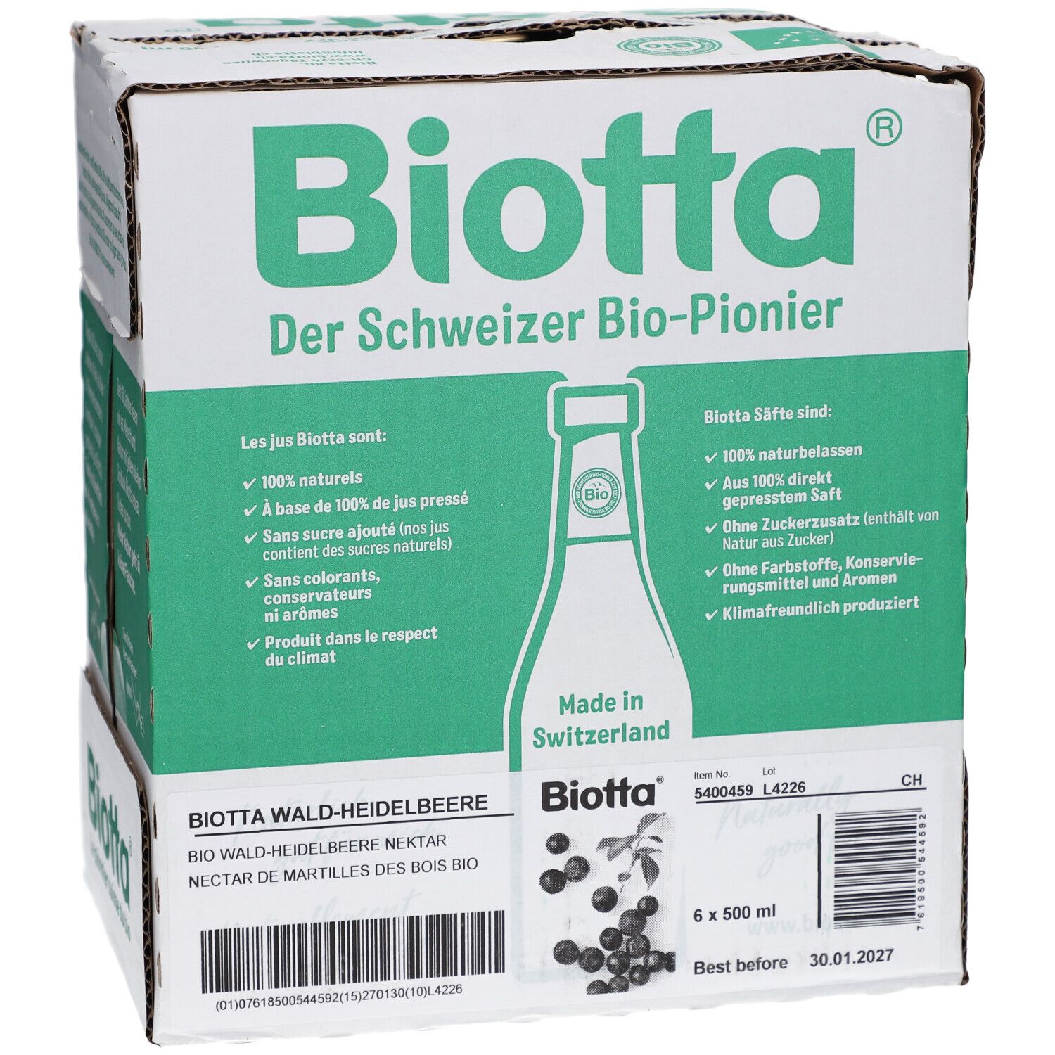 Karton mit BIOTTA Waldheidelbeere Bio. Sechs Flaschen, grüne und weiße Verpackung. Text: Der Schweizer Bio-Pionier. Produktetikett.