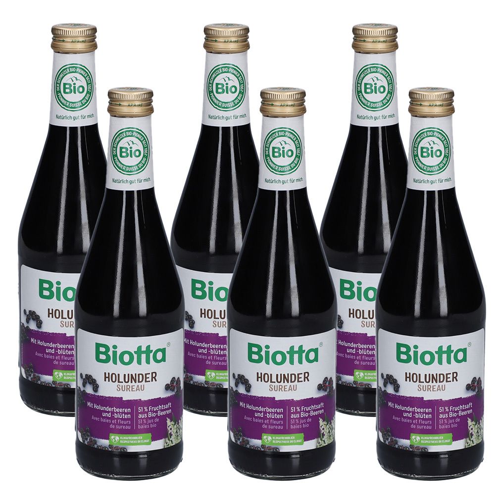 Sechs Flaschen Biotta Holunder Sureau. Jede Flasche hat ein Etikett mit Produktinformationen und einem Bio-Siegel. Goldfarbene Verschlüsse.