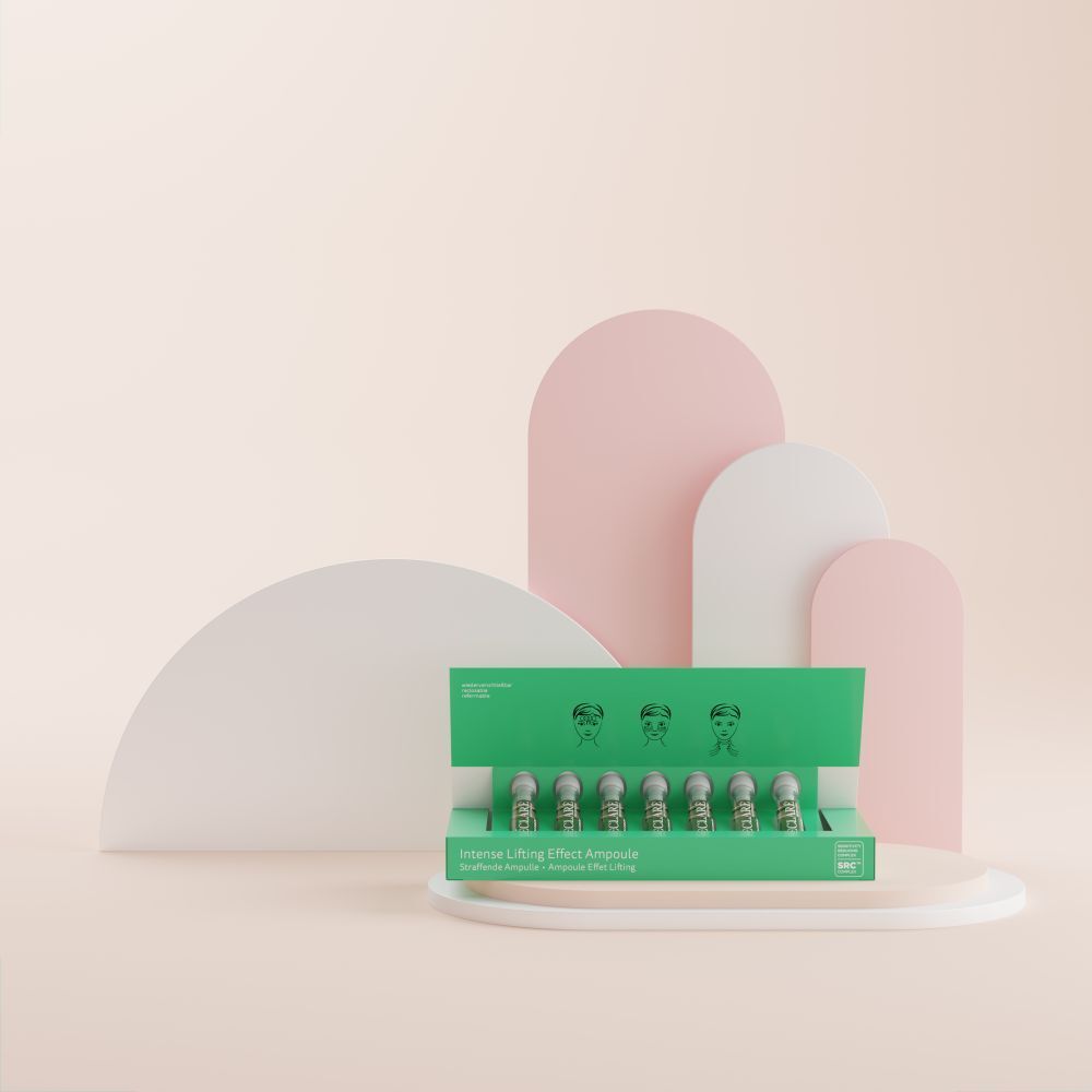 Boîte verte avec ampoules. Inscription: Intense Lifting Effect Ampoule. Sur fond rose et blanc.