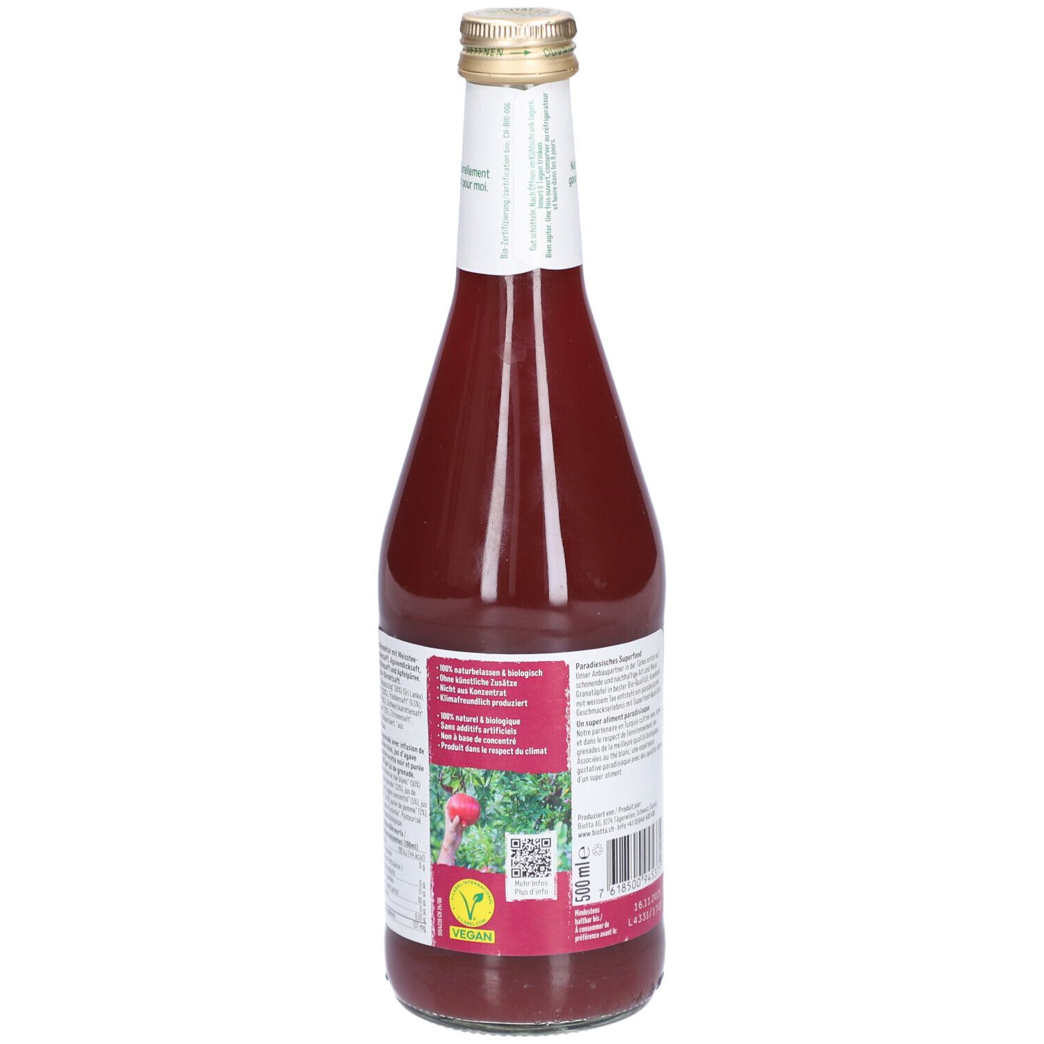 Rückseite der Glasflasche mit rotem Saft. Text, Bio-Siegel und Vegan-Logo. BIOTTA Granatapfel.