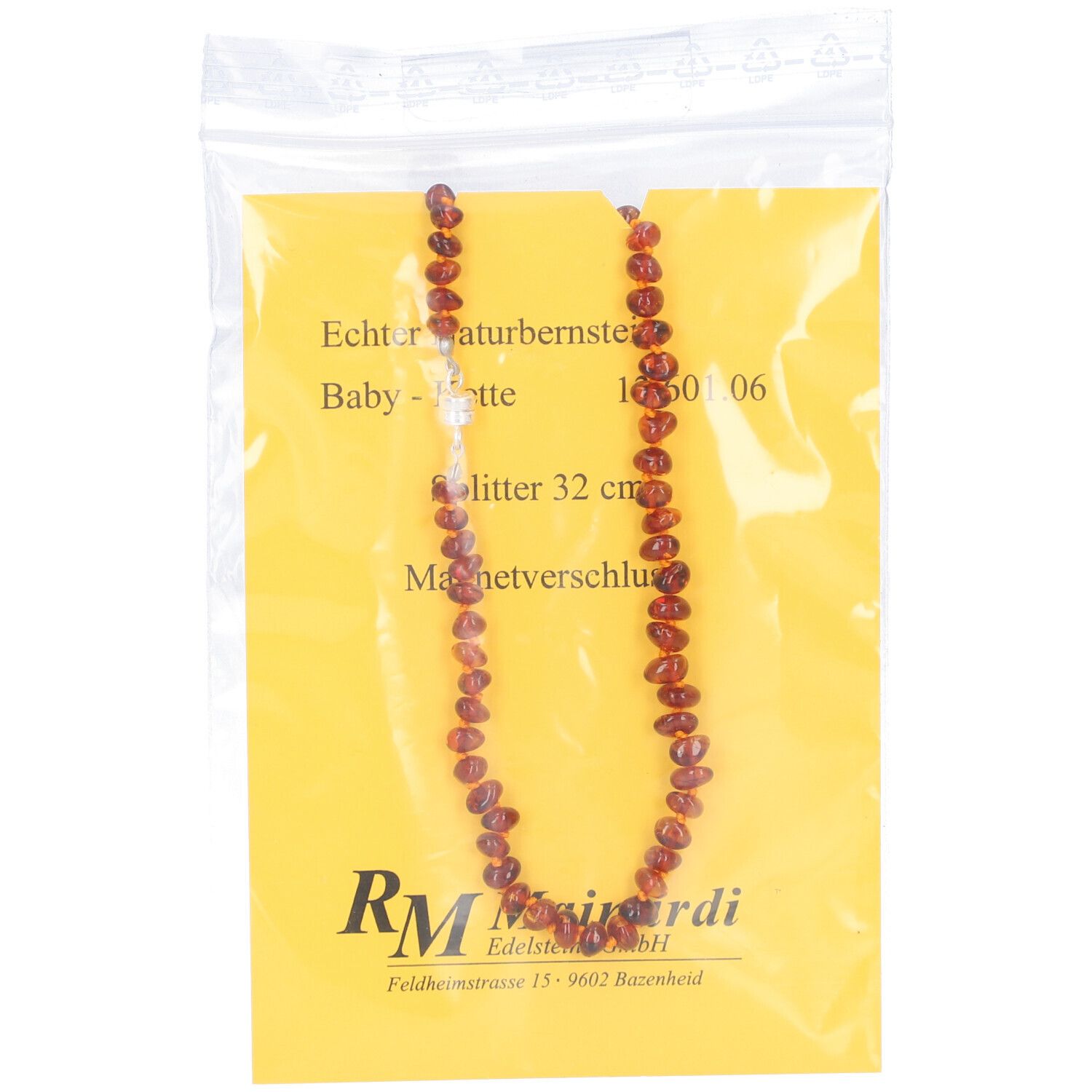 Bernsteinkette in Plastikverpackung. 32 cm lang, mit Magnetverschluss. Auf gelbem Hintergrund. Marke MAINARDI.