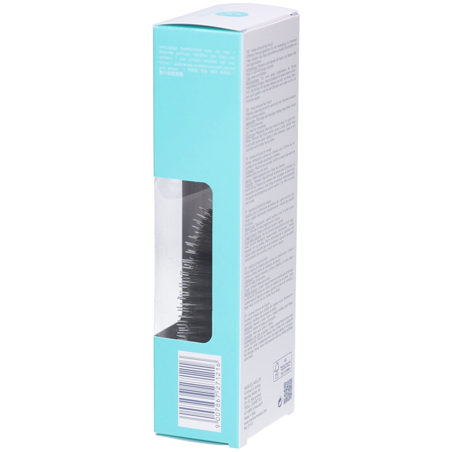 Emballage blanc et turquoise. Marlies Möller. Fenêtre. Brosse à cheveux visible.