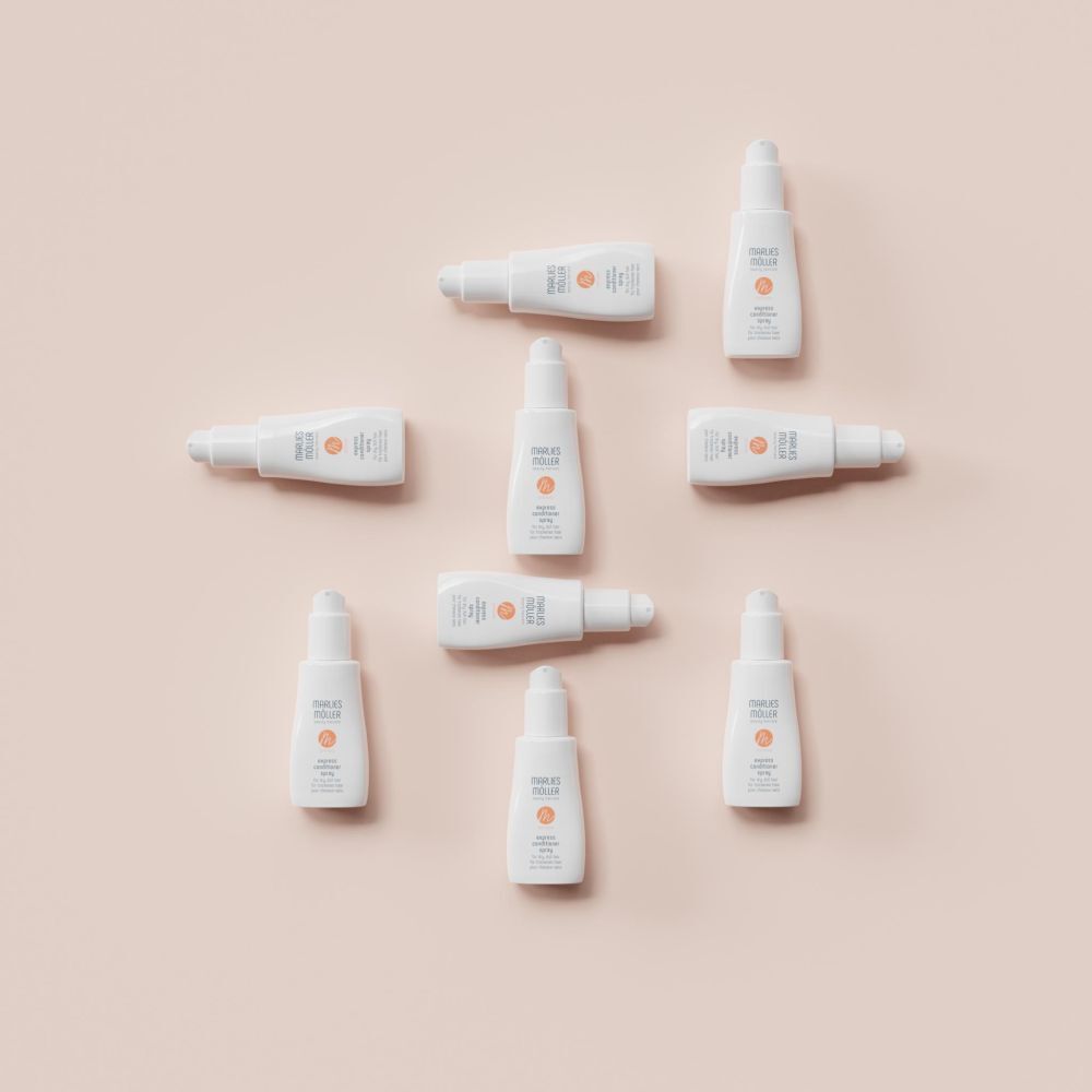 Plusieurs flacons blancs sur fond rose. Inscription: Marlies Möller, softness, Express Conditioner Spray.