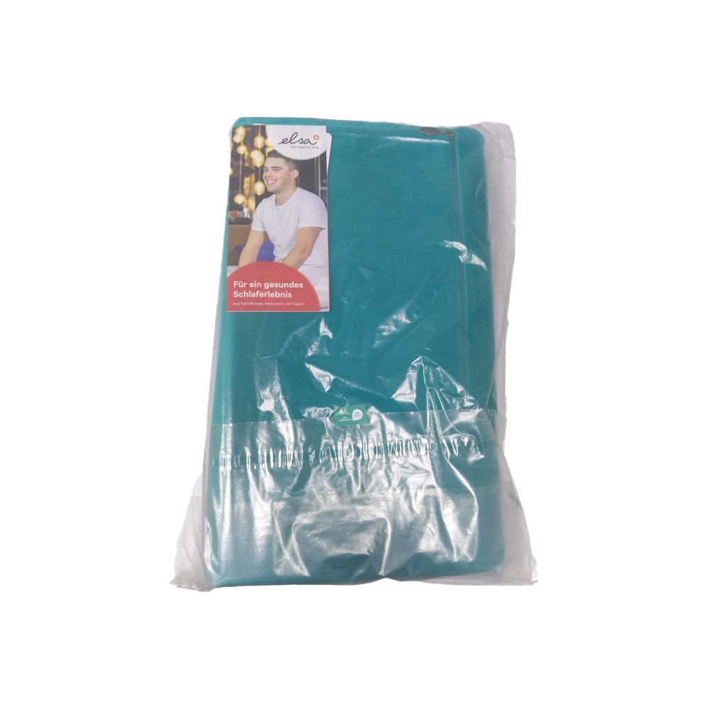 Coussin de nuque turquoise dans un emballage plastique. Autocollant avec logo et homme. Texte : Pour un sommeil sain.