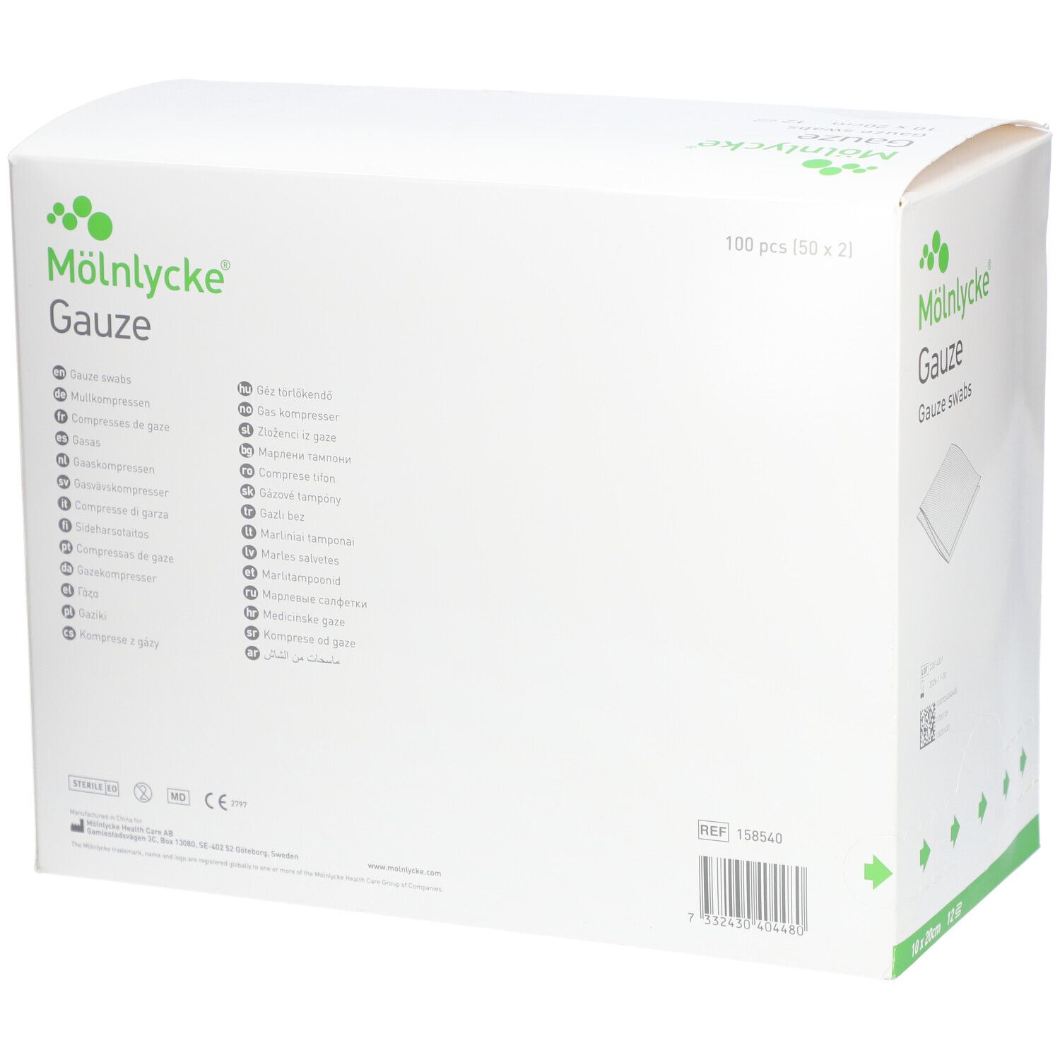 Boîte blanche. Inscription: MÖLNLYCKE® Gauze, 10x20cm, 12 pièces. Texte en plusieurs langues.