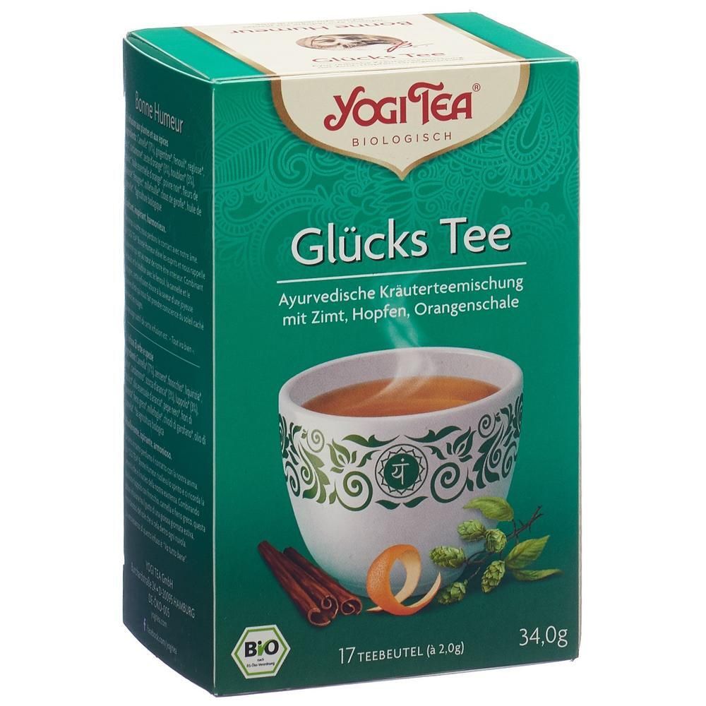 Yogi Tea Glucks Tee. Kräutermischung mit Zimt, Hopfen, Orangenschale. 17 Teebeutel. Bio-Siegel. Grün-weiße Verpackung mit Tee-Illustration.