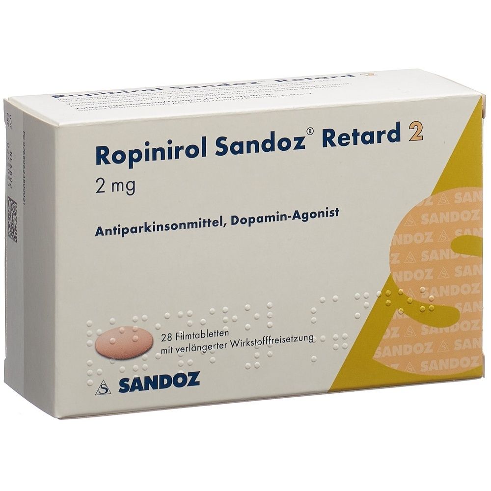 Karton mit Medikamenten. Aufschrift: Ropinirol Sandoz Retard, 2 mg. Gelb-weiße Verpackung.