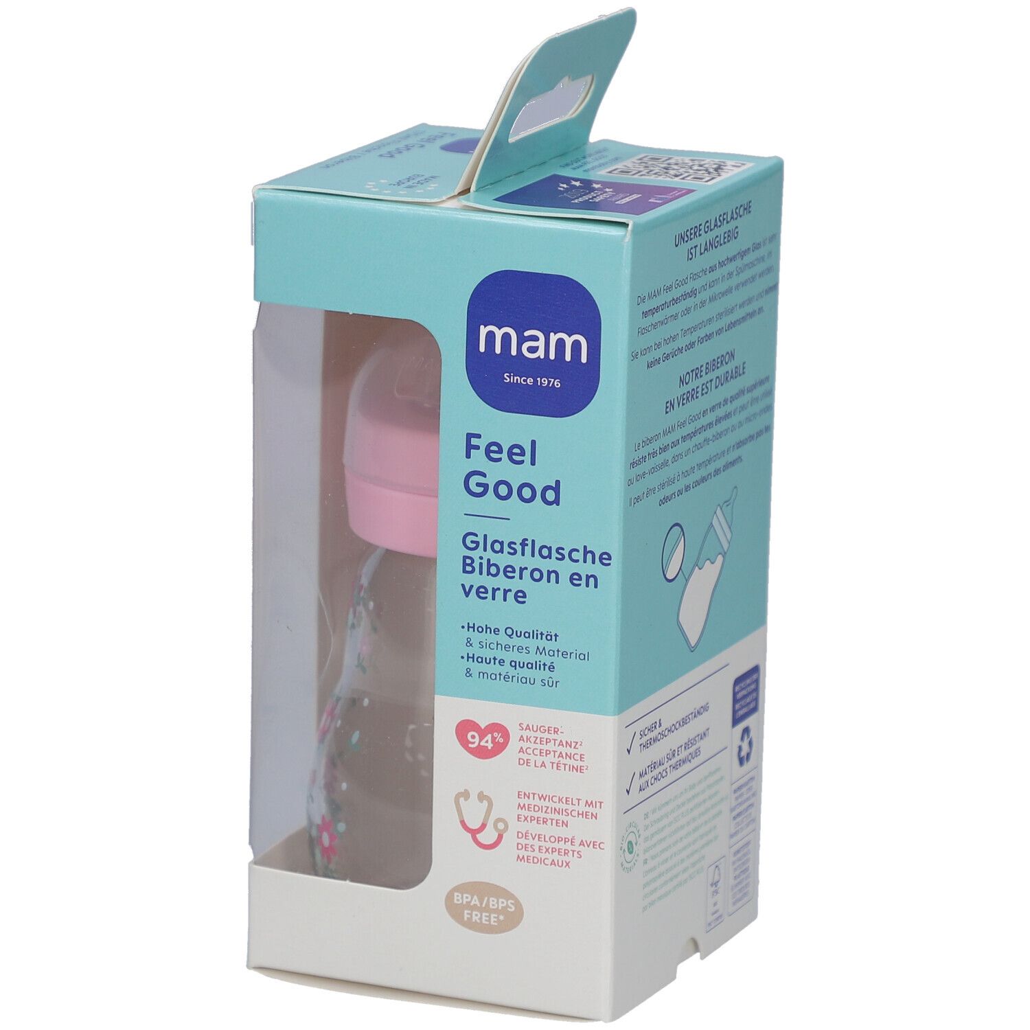 Biberon dans son emballage. Tétine rose, bouteille transparente à motifs floraux. Emballage avec nom et logo du produit.