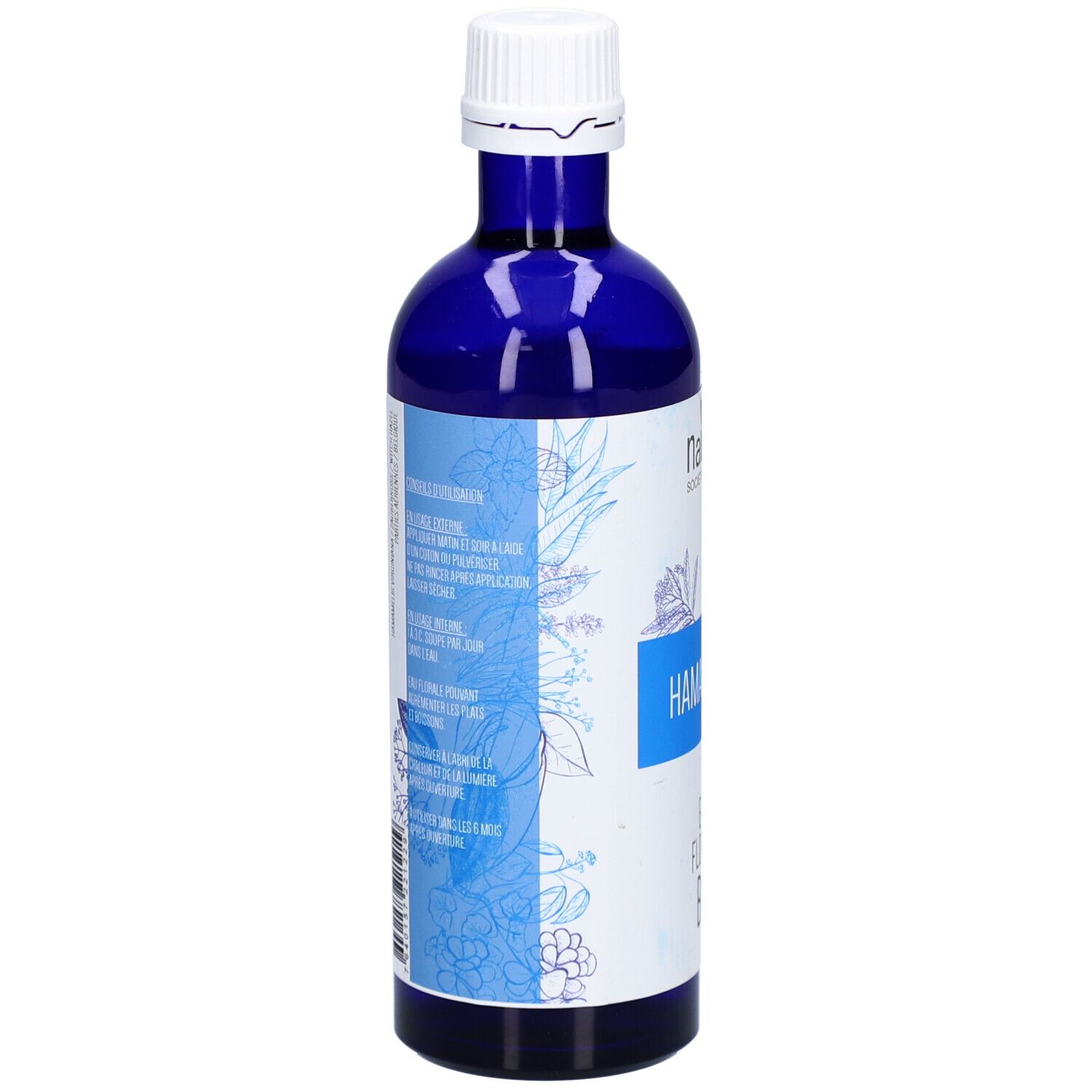 Blaue Glasflasche. Aufschrift: HAMAMÉLIS, EAU FLORALE BIO. Text in mehreren Sprachen. Floral-Design.