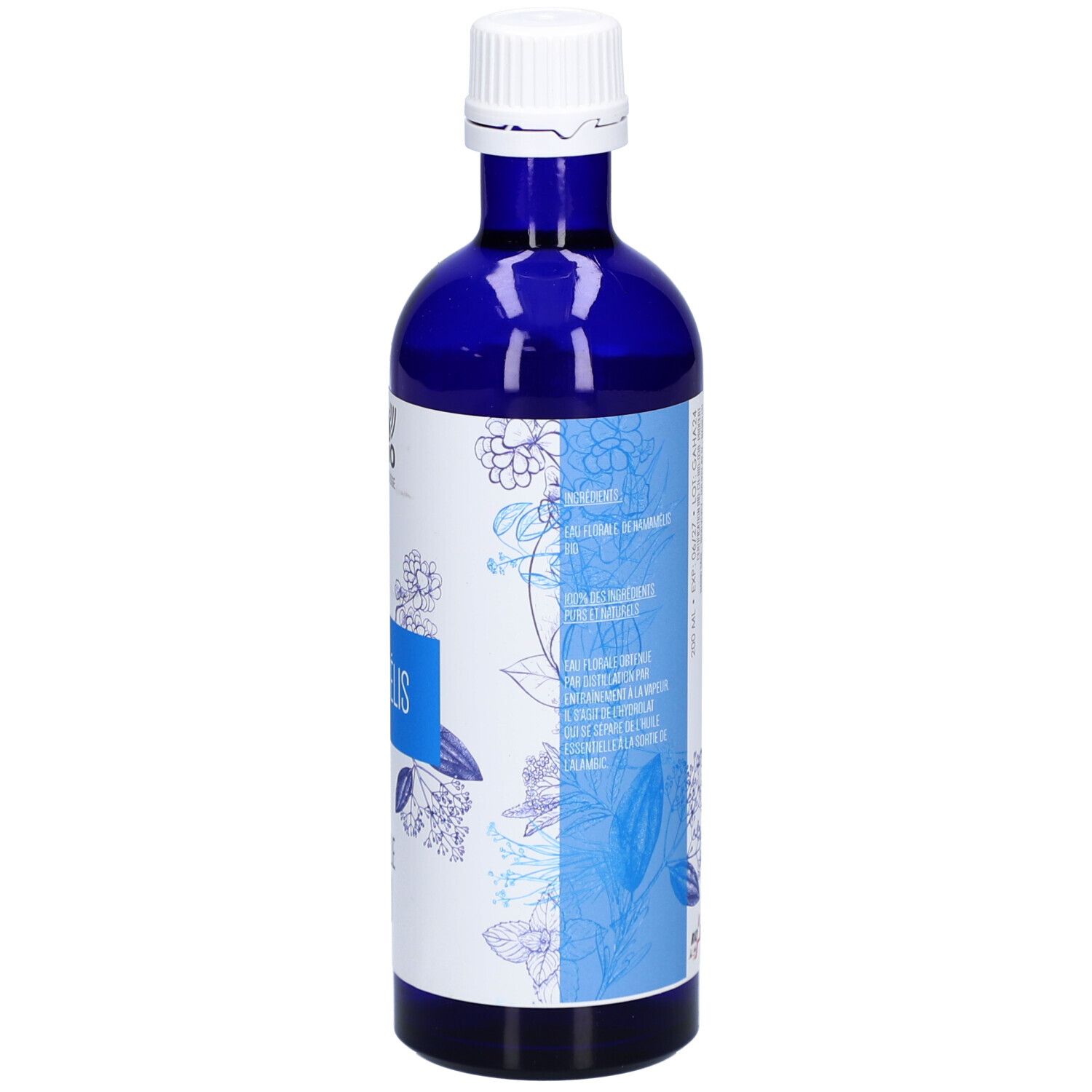 Blaue Glasflasche. Aufschrift: HAMAMÉLIS, EAU FLORALE BIO. Text in mehreren Sprachen. Floral-Design.