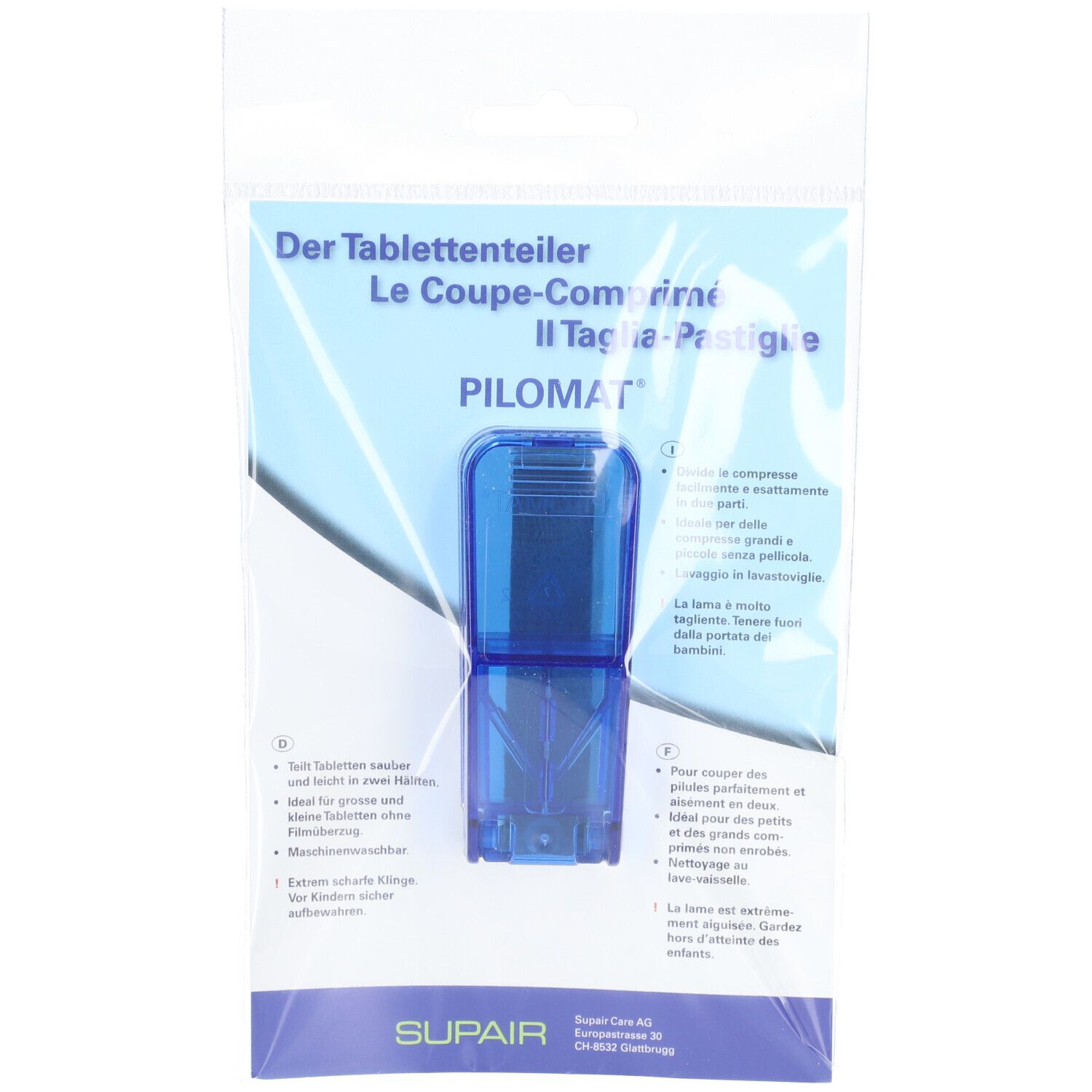 Blauer Tablettenteiler in Verpackung. Text: PILOMAT, Der Tablettenteiler, Le Coupe-comprimé, Il Taglia-Pastiglie.