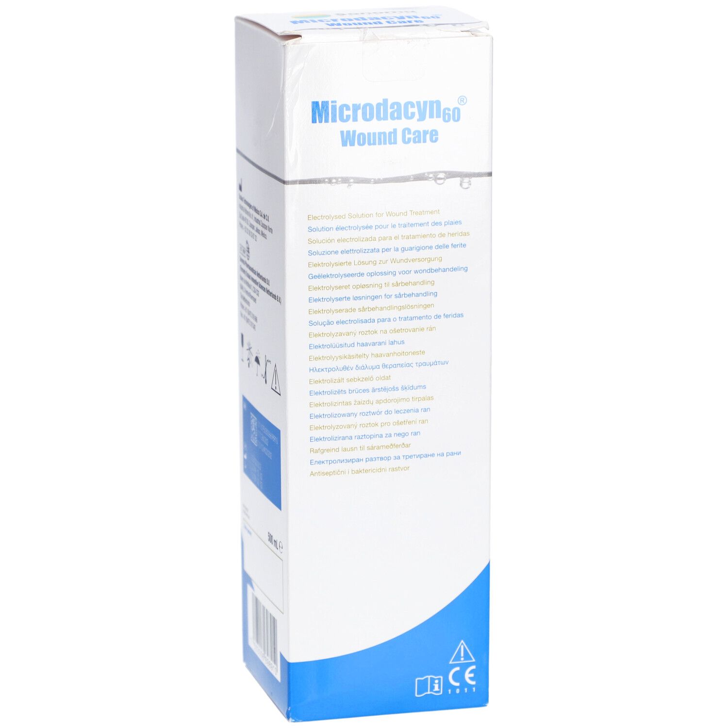 Boîte Microdacyn60 Wound Care. Blanche avec base bleue. Texte multilingue. Contient des informations et des symboles.